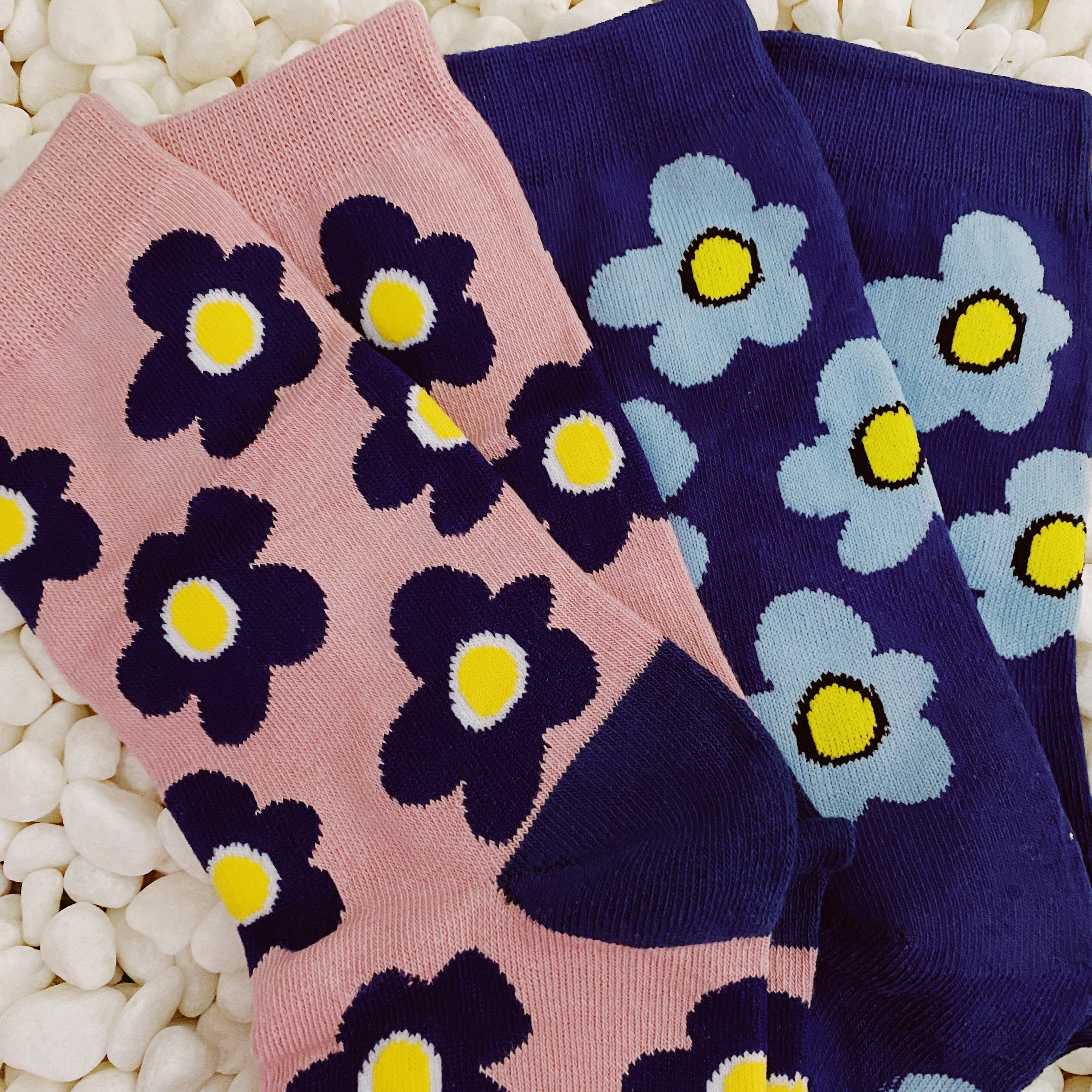 A set of two pairs of modern daisy socks featuring a unique daisy pattern in soft, stretchy material, perfect for comfortable wear.