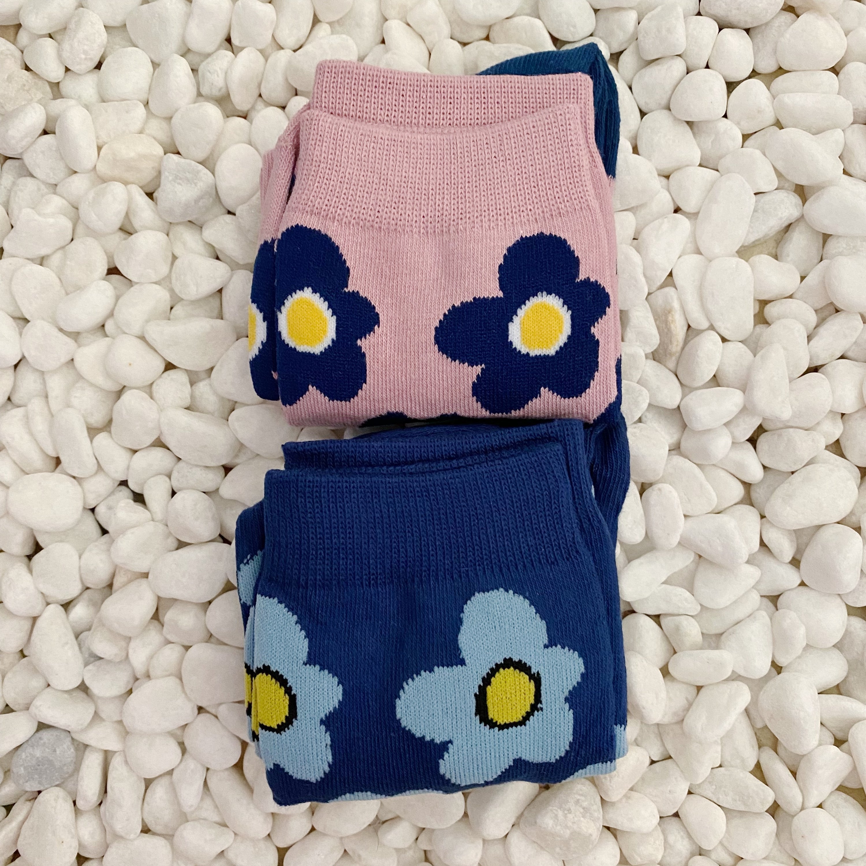 A set of two pairs of modern daisy socks featuring a unique daisy pattern in soft, stretchy material, perfect for comfortable wear.