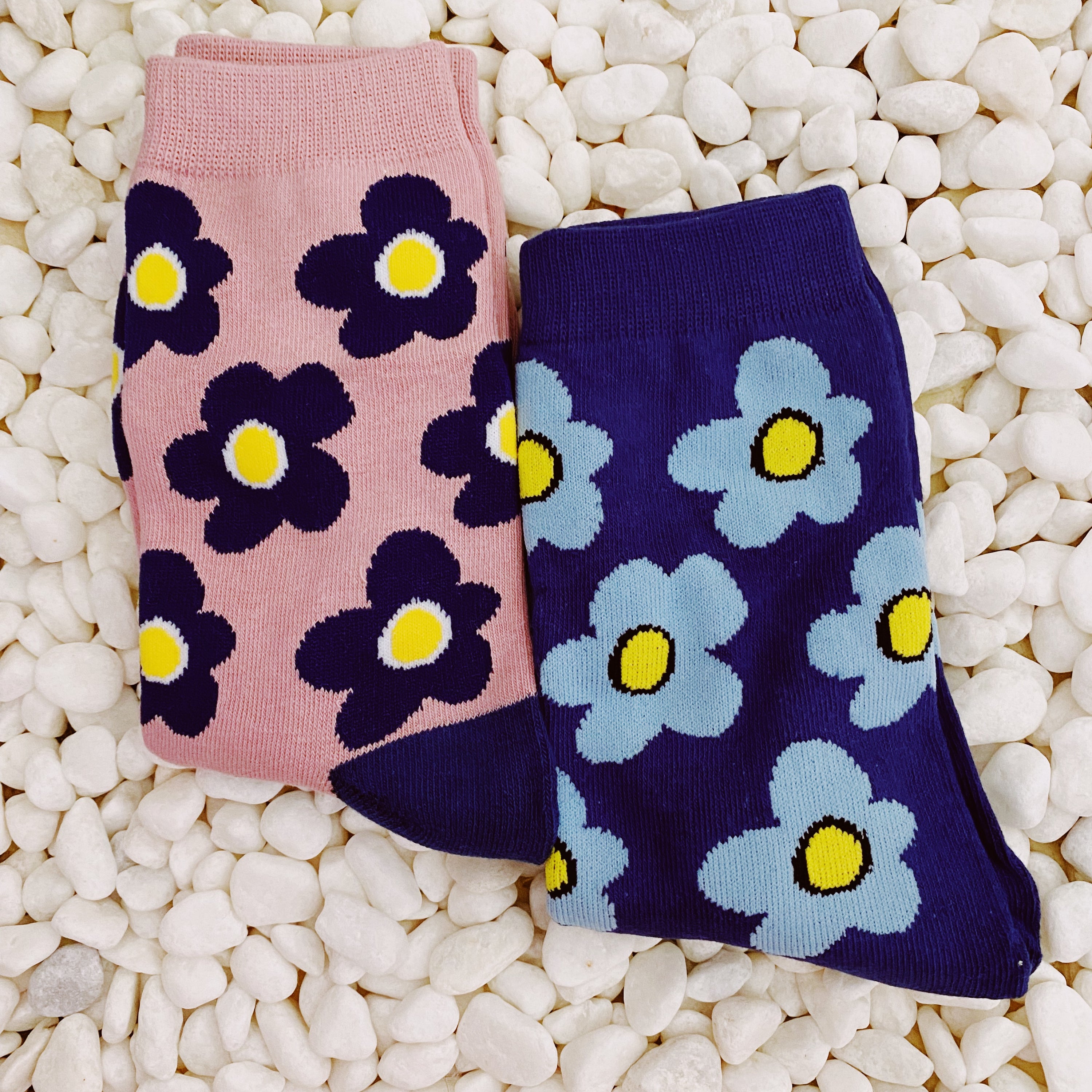 A set of two pairs of modern daisy socks featuring a unique daisy pattern in soft, stretchy material, perfect for comfortable wear.