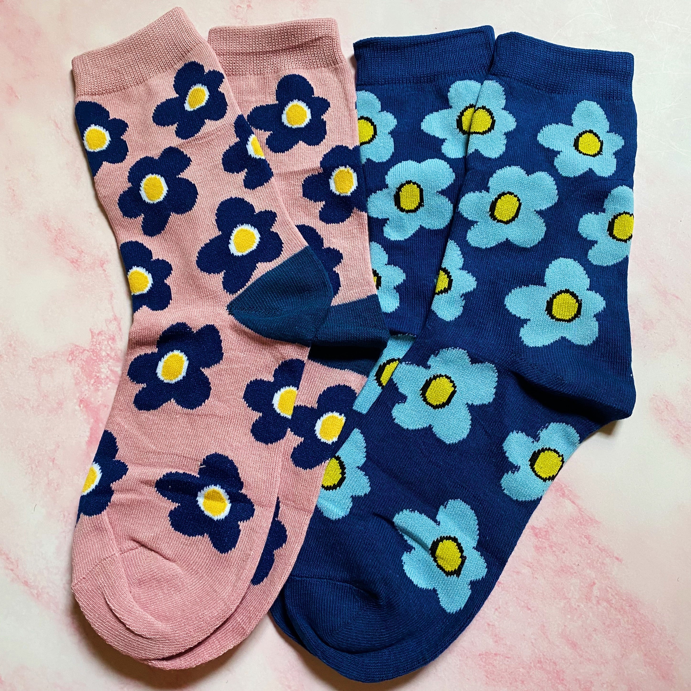 A set of two pairs of modern daisy socks featuring a unique daisy pattern in soft, stretchy material, perfect for comfortable wear.