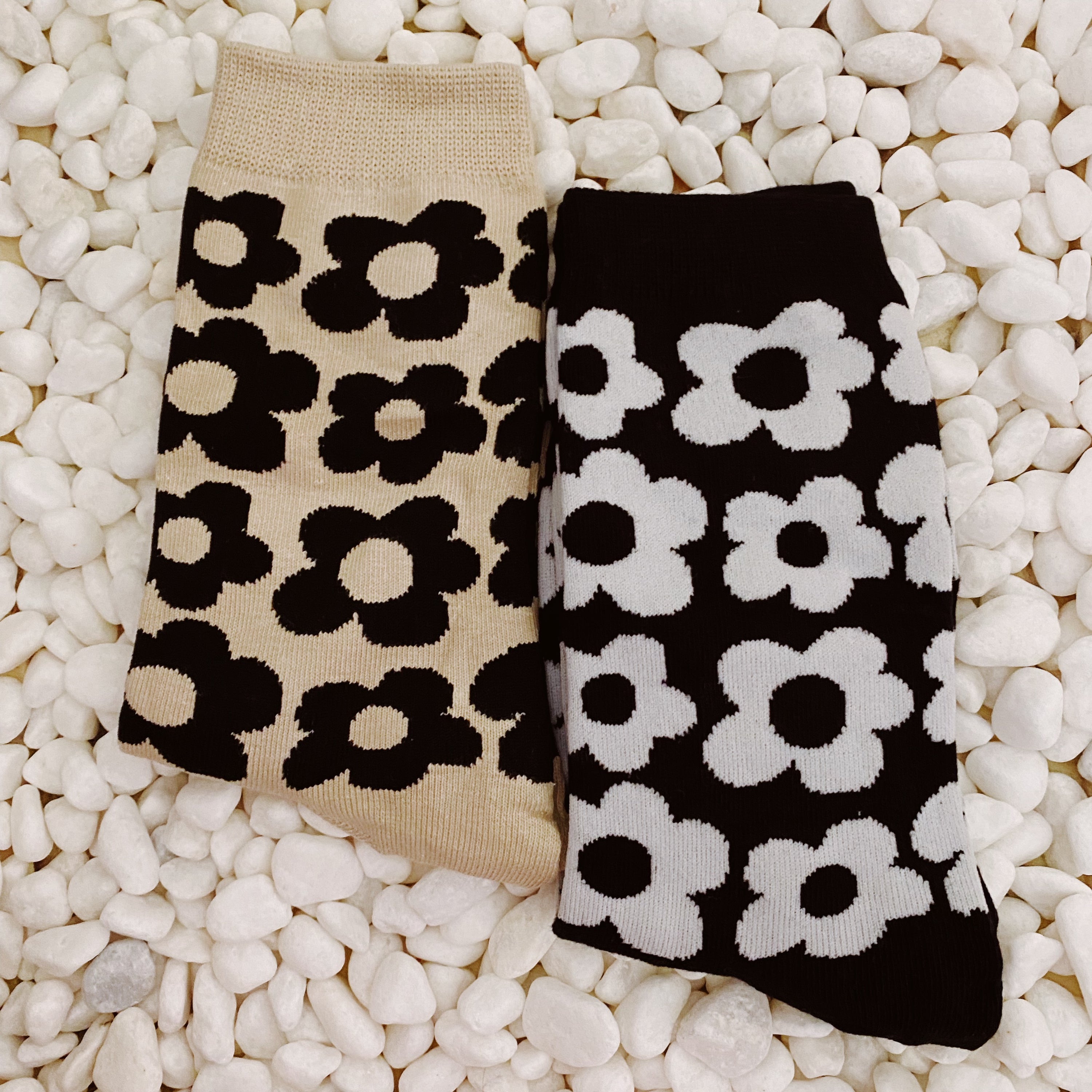 A set of two pairs of modern daisy socks featuring a unique daisy pattern in soft, stretchy material, perfect for comfortable wear.