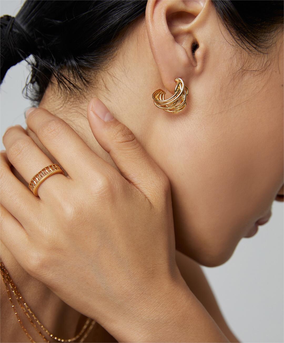 A pair of Modern Wave Hoop Earrings made from sterling silver and gold vermeil, showcasing a unique wave design.