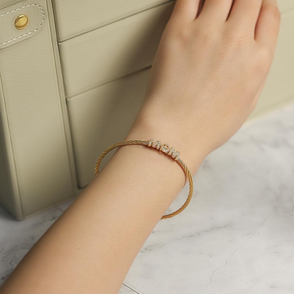 Elegant 'Mom' Pavé Bracelet made of stainless steel with gold plating, showcasing a delicate design perfect for everyday wear.