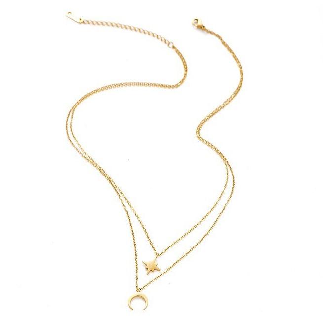 A dainty layered necklace featuring a moon and star design, crafted from 14k gold plated brass, elegantly displayed in a gift box.