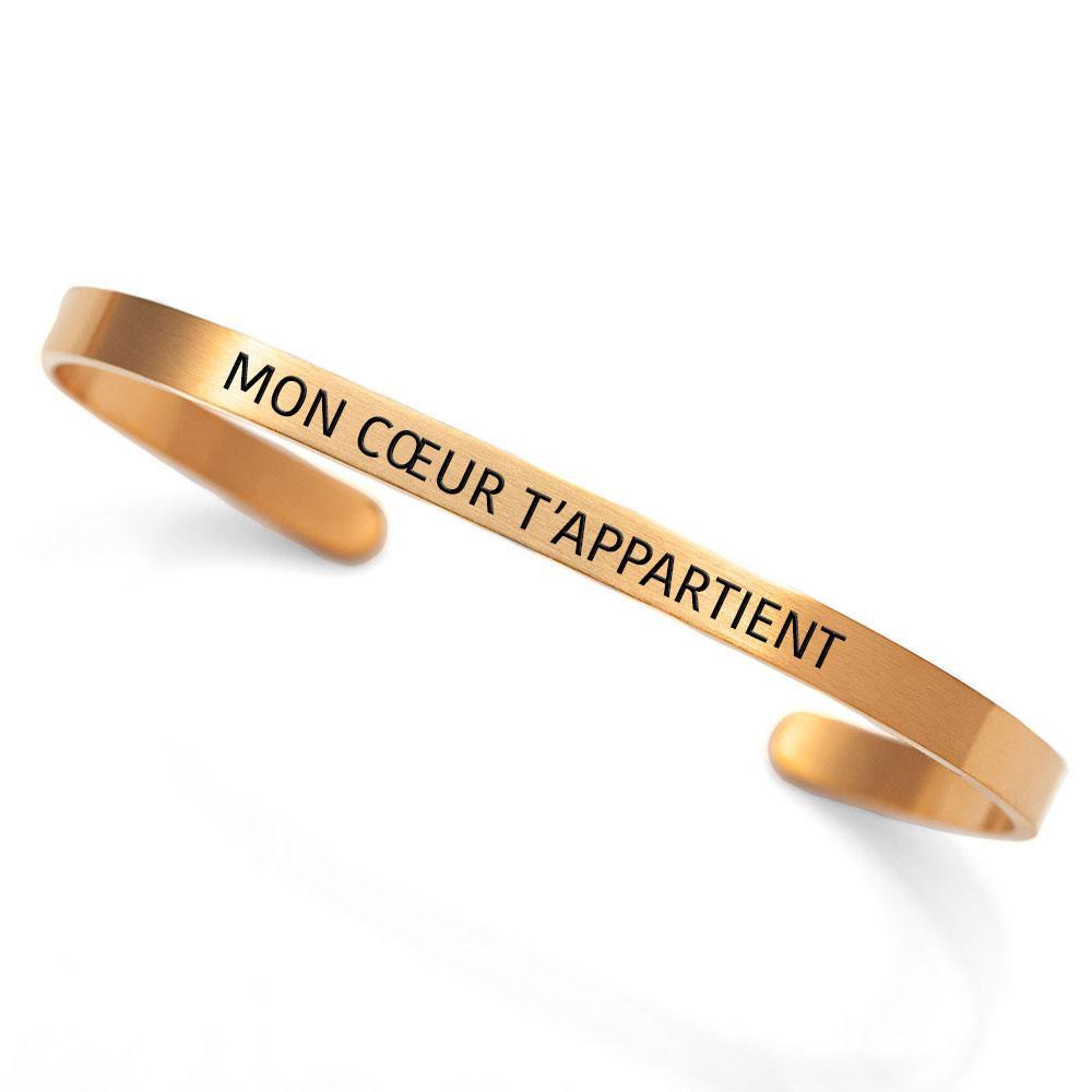 Dainty cuff bracelet with the phrase 'Mon coeur t'appartient' in elegant rose gold finish, showcasing French inspiration.