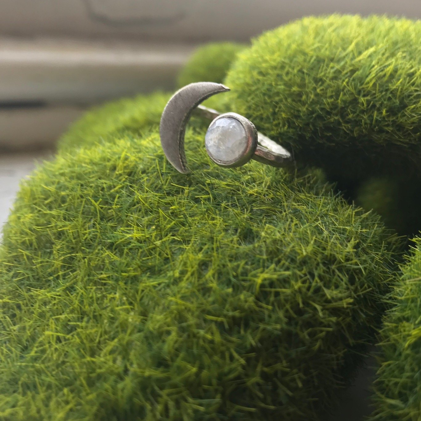 Moon Goddess Ring featuring a hammered crescent design and a 6mm rainbow Moonstone, available in gold and silver tones.