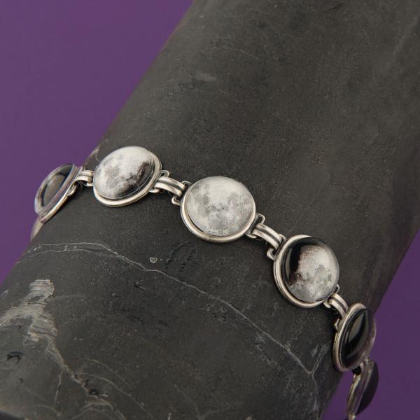 Moon Phase Bracelet showcasing seven lunar phases in antique silver and bronze finishes, handcrafted with plated brass and glass.