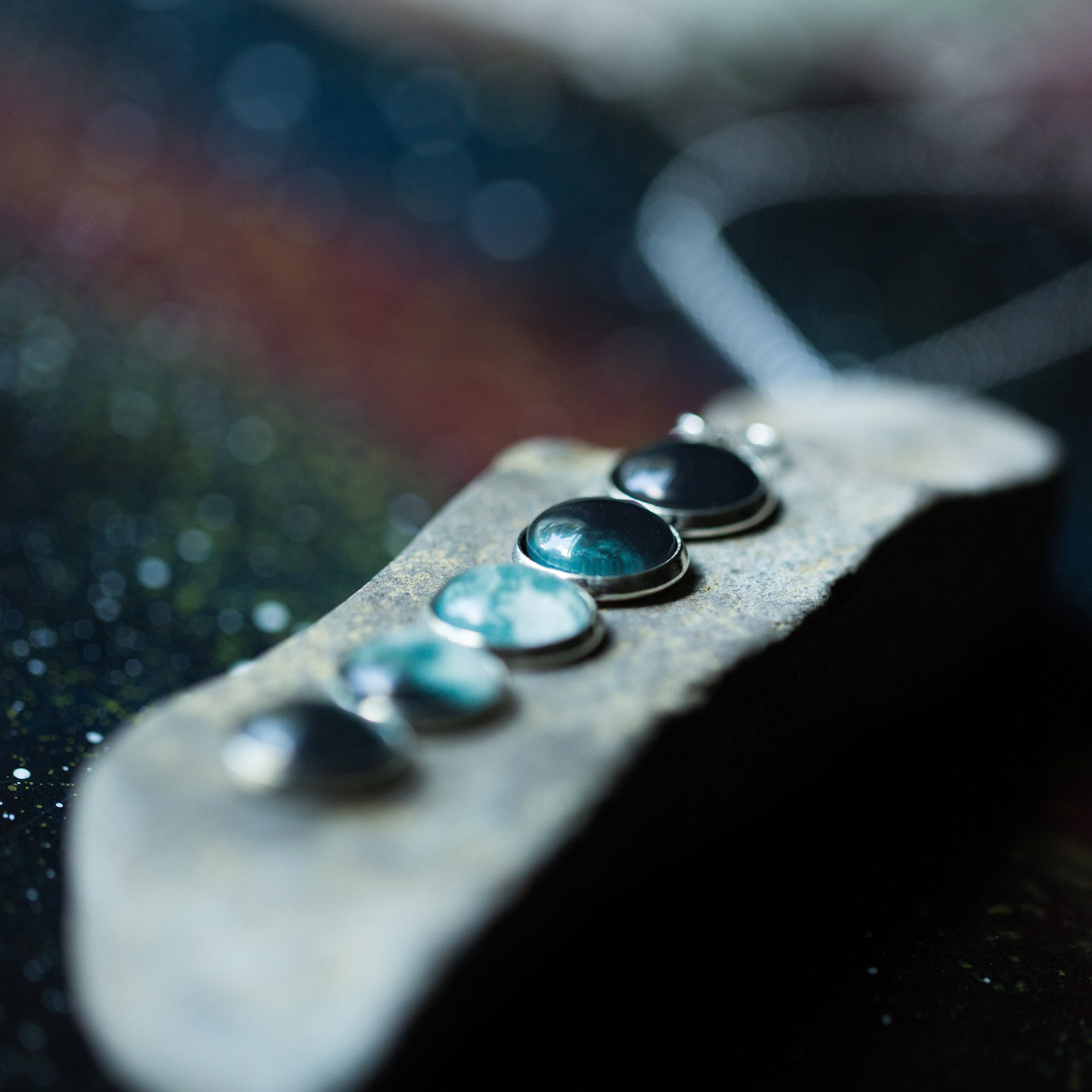 Moon Phase Pendant Necklace featuring silver tone bezels with lunar designs, elegantly hanging from an 18-inch chain.