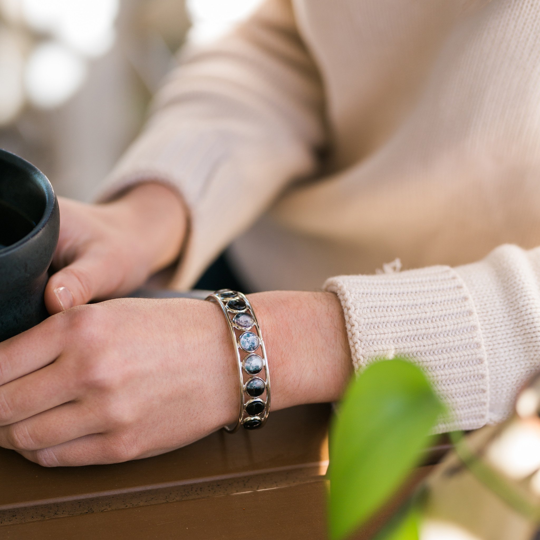 Moon Phase Silver Cuff Bracelet showcasing 9 lunar phases on an adjustable cuff, handcrafted with rhodium plated brass and glass accents.