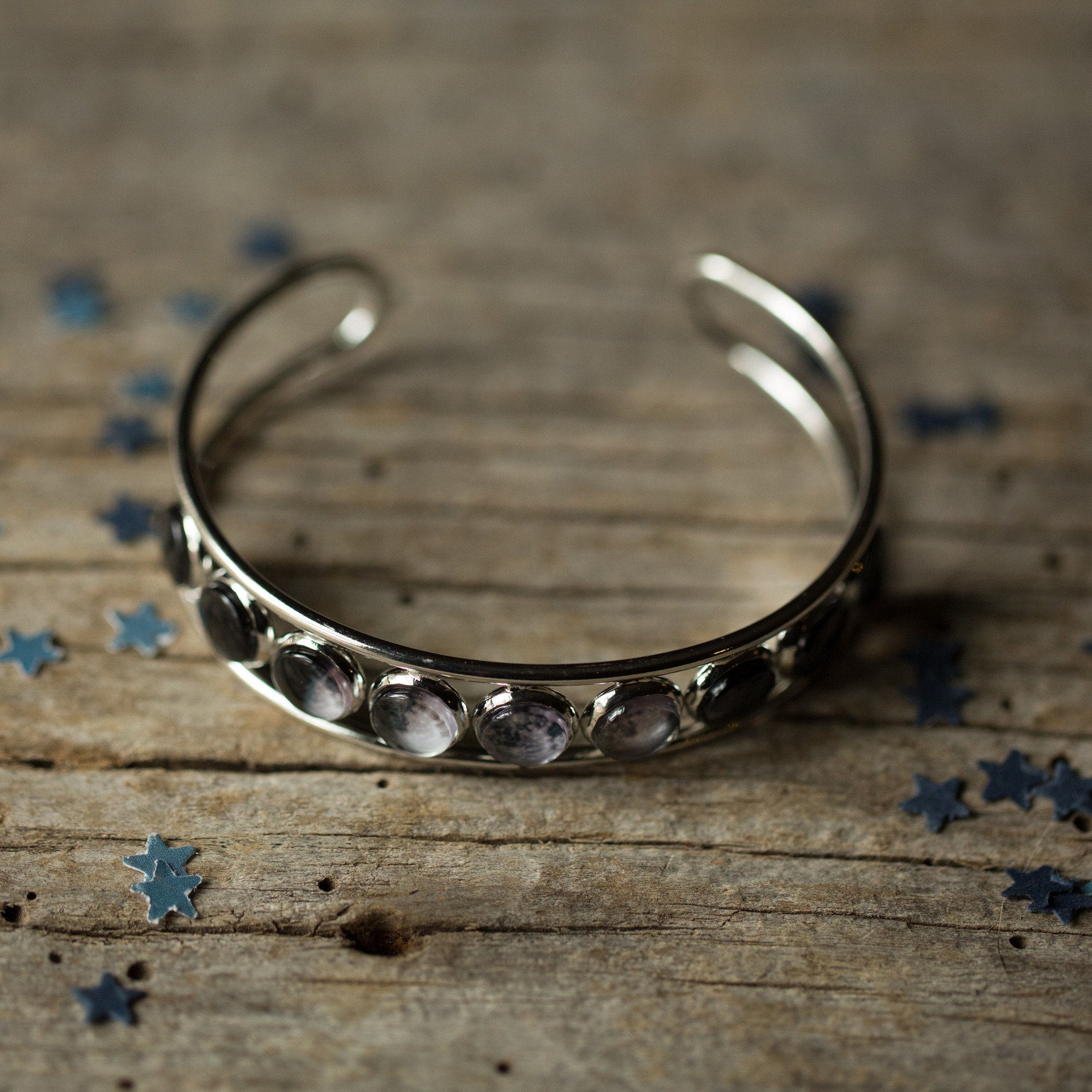 Moon Phase Silver Cuff Bracelet showcasing 9 lunar phases on an adjustable cuff, handcrafted with rhodium plated brass and glass accents.