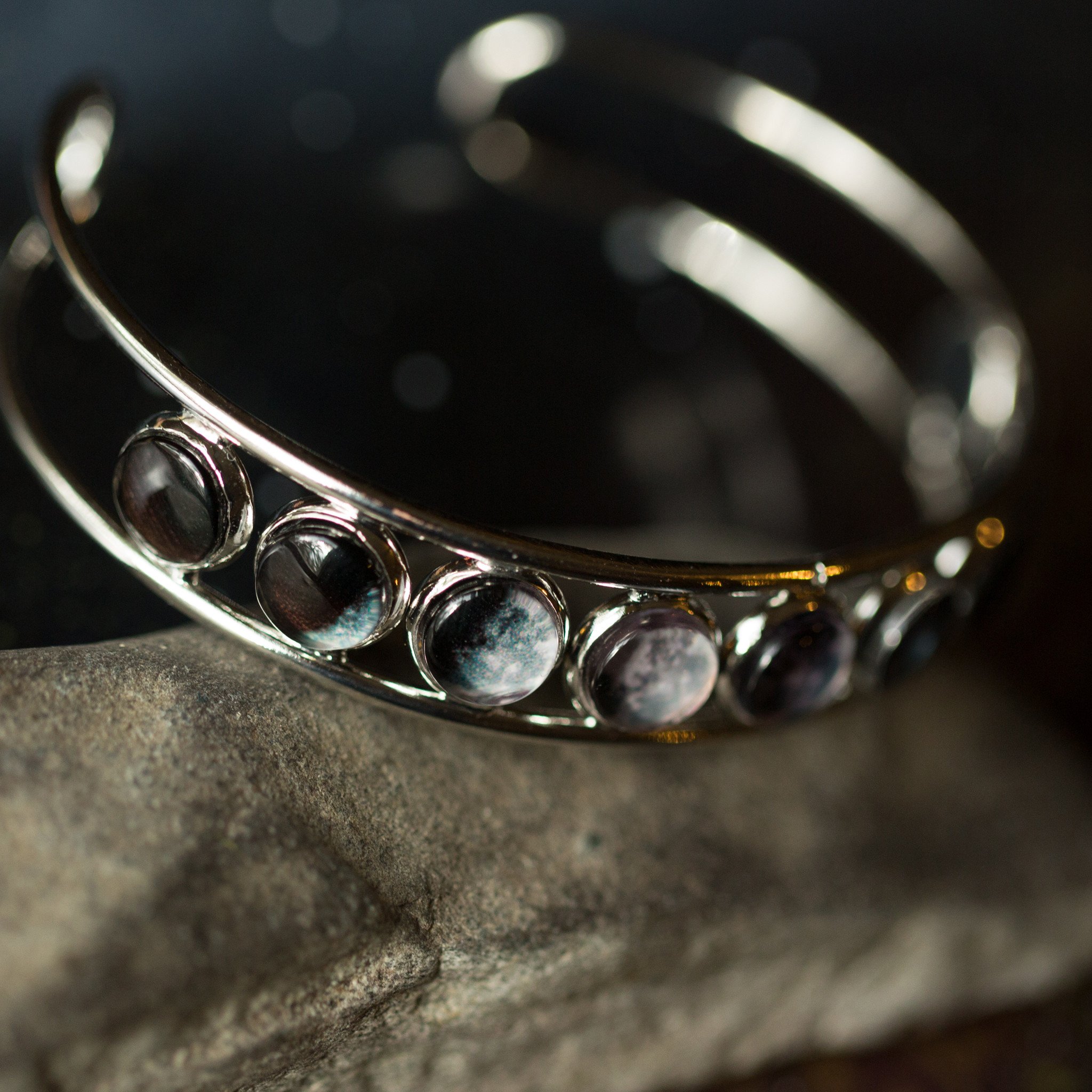 Moon Phase Silver Cuff Bracelet showcasing 9 lunar phases on an adjustable cuff, handcrafted with rhodium plated brass and glass accents.