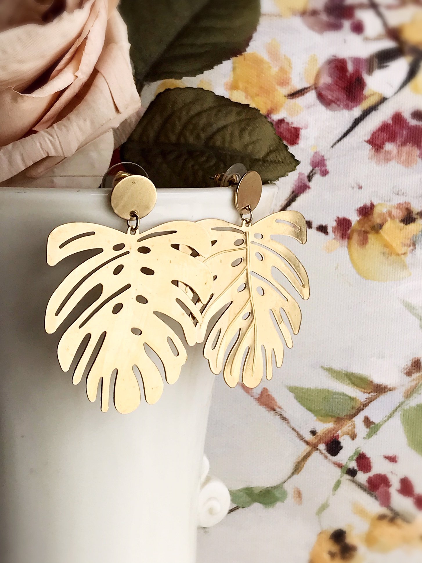 Brushed brass monstera leaf earrings with stainless steel ear posts, showcasing a unique and stylish design.