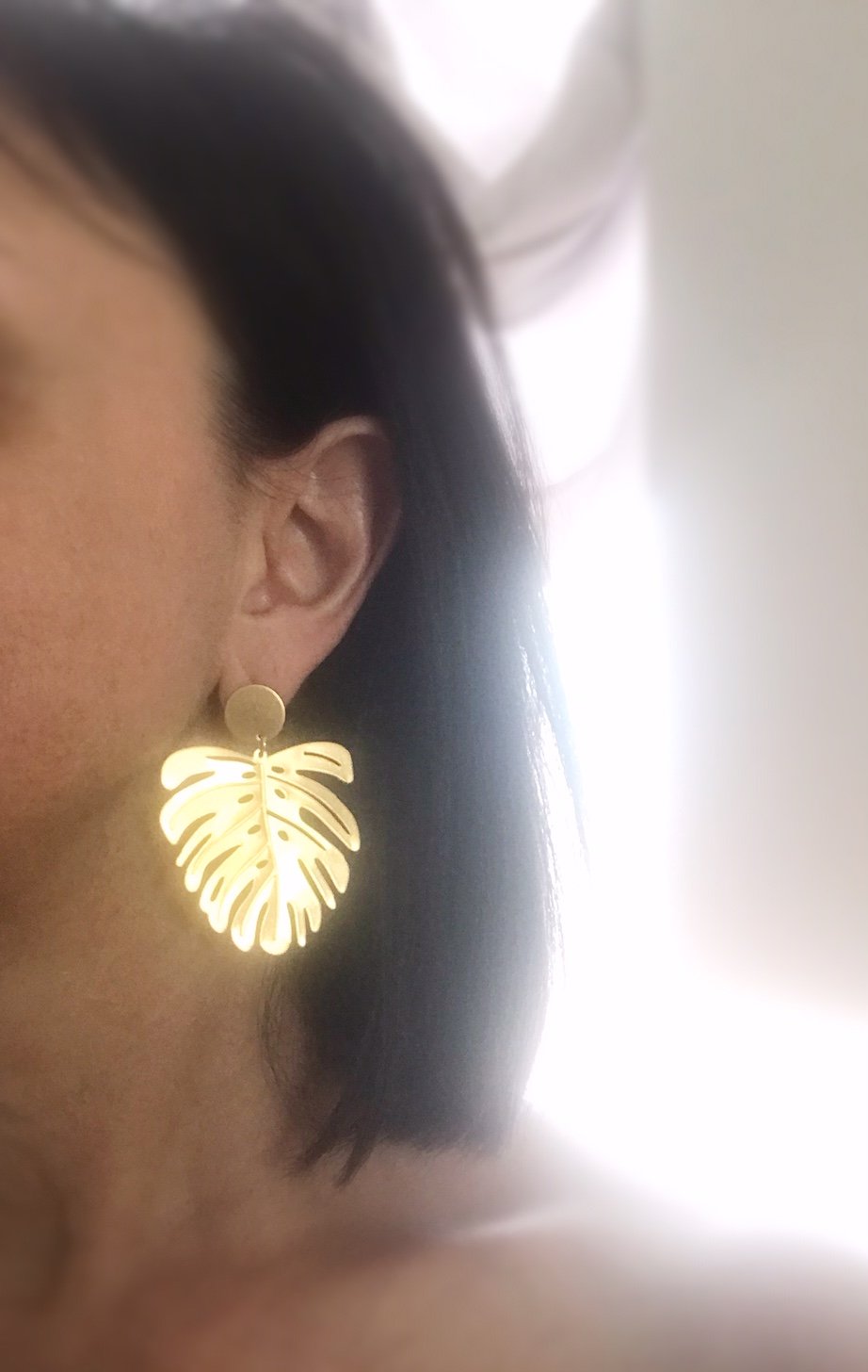 Brushed brass monstera leaf earrings with stainless steel ear posts, showcasing a unique and stylish design.