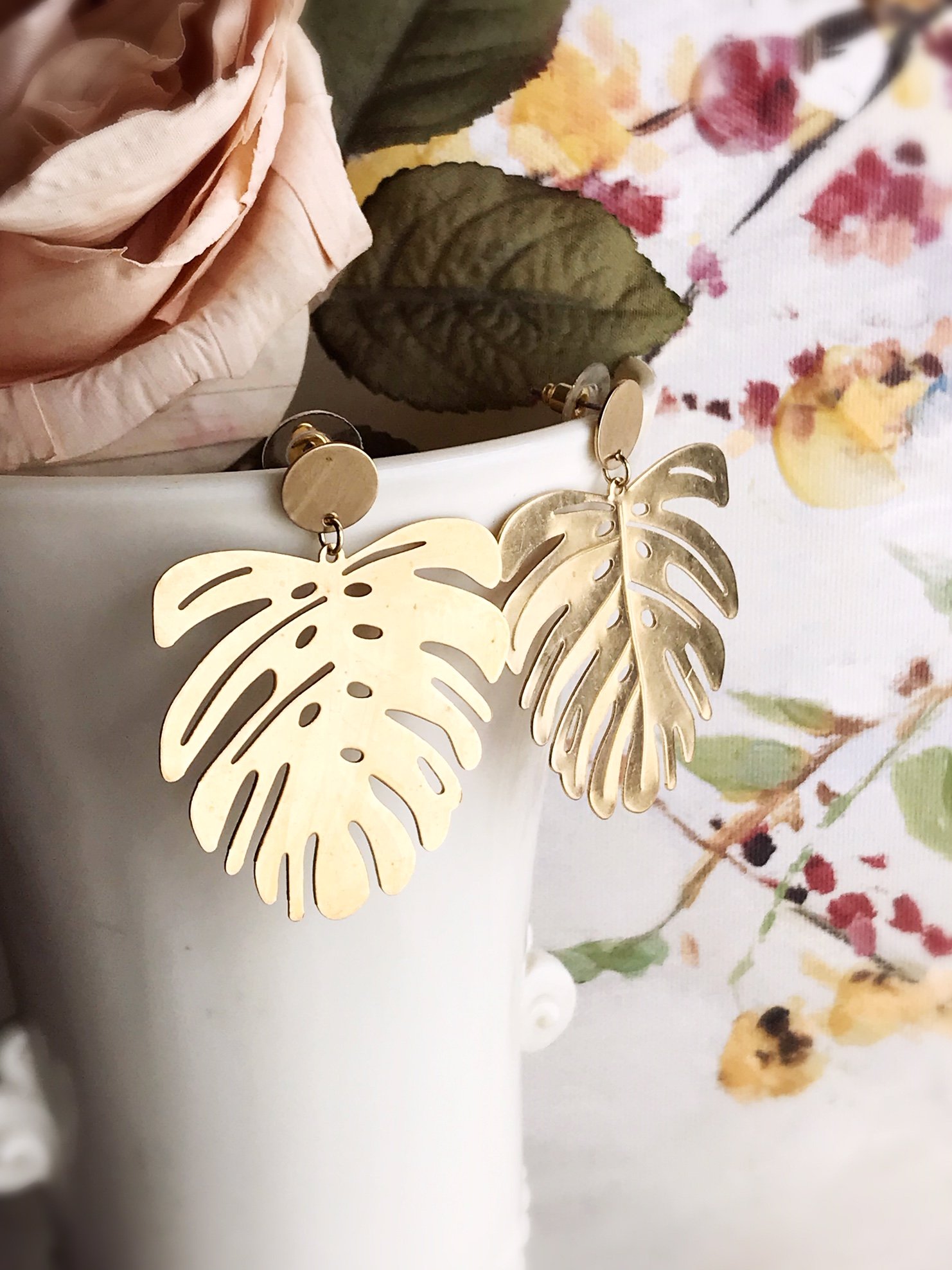 Brushed brass monstera leaf earrings with stainless steel ear posts, showcasing a unique and stylish design.