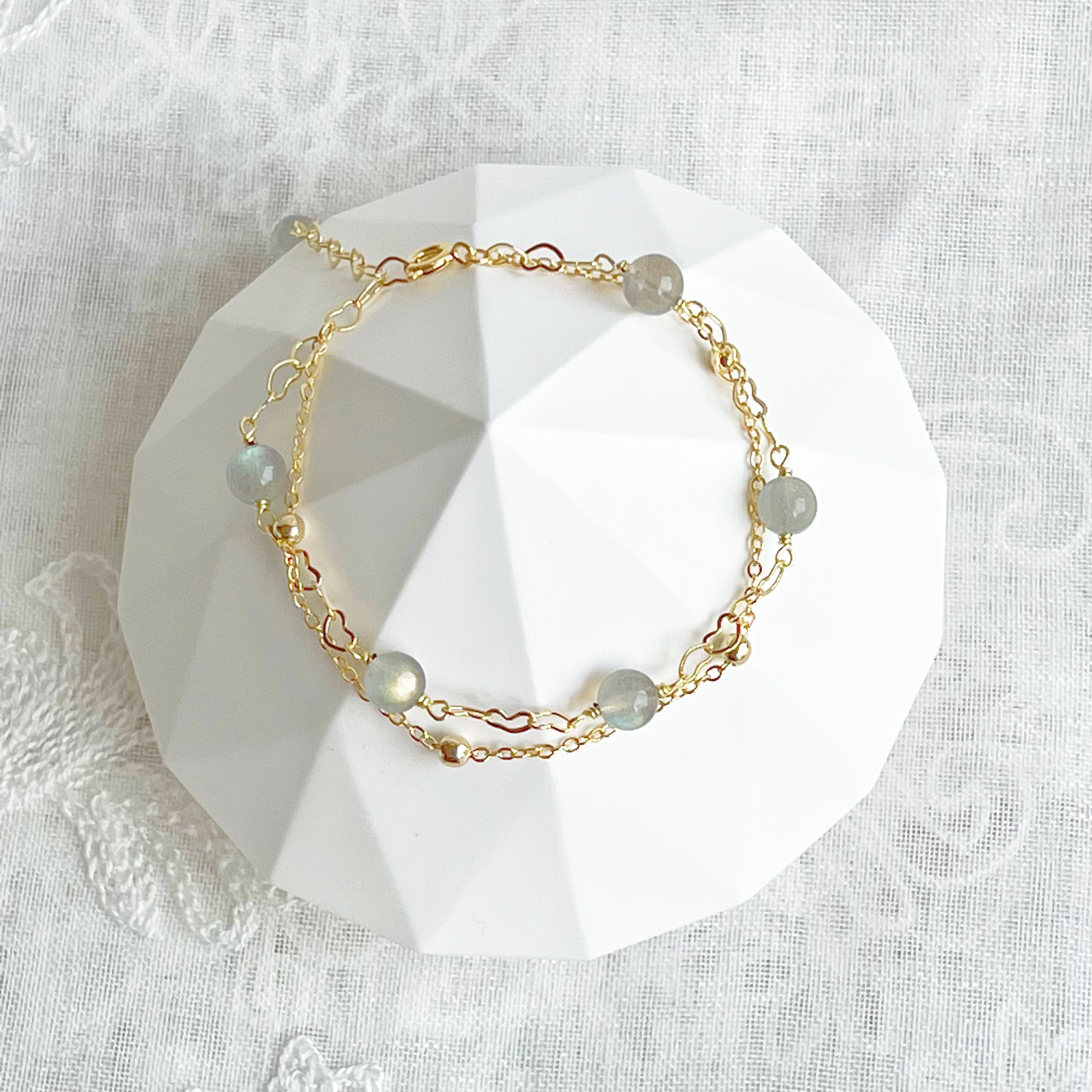 Moonstone Gold Heart Double Chain Bracelet featuring 6mm moonstone beads and gold plated bronze chain, elegantly designed for a stylish look.