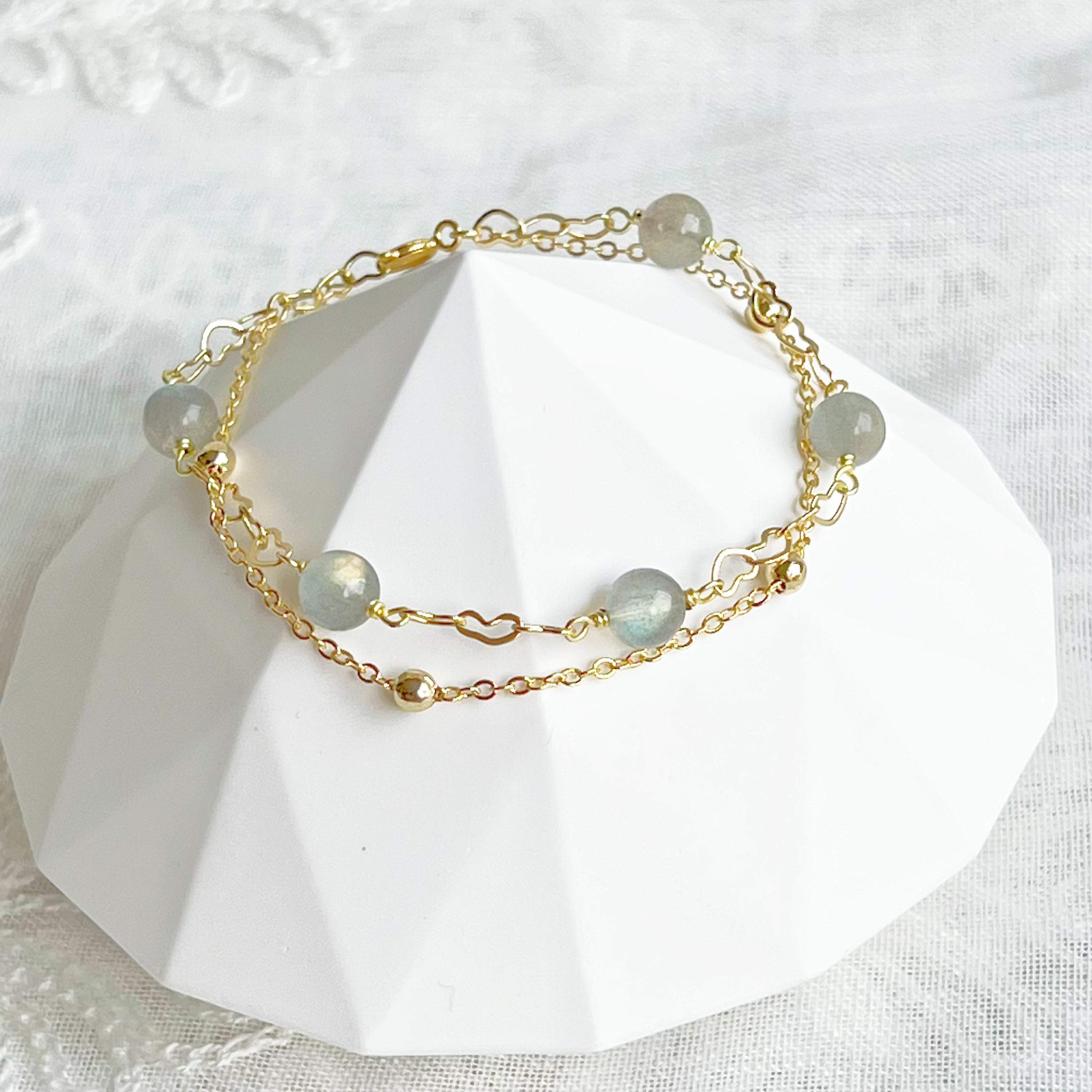 Moonstone Gold Heart Double Chain Bracelet featuring 6mm moonstone beads and gold plated bronze chain, elegantly designed for a stylish look.