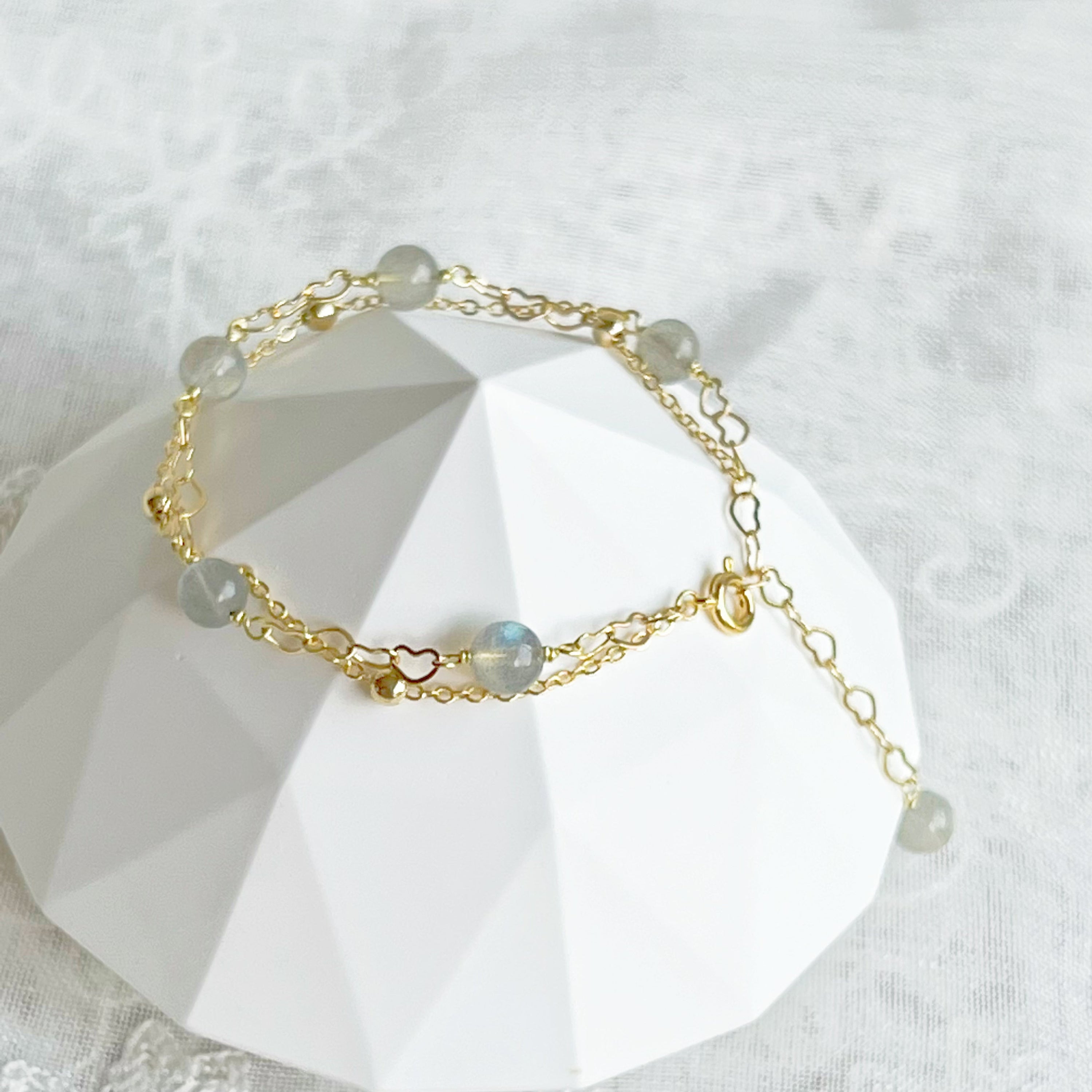 Moonstone Gold Heart Double Chain Bracelet featuring 6mm moonstone beads and gold plated bronze chain, elegantly designed for a stylish look.