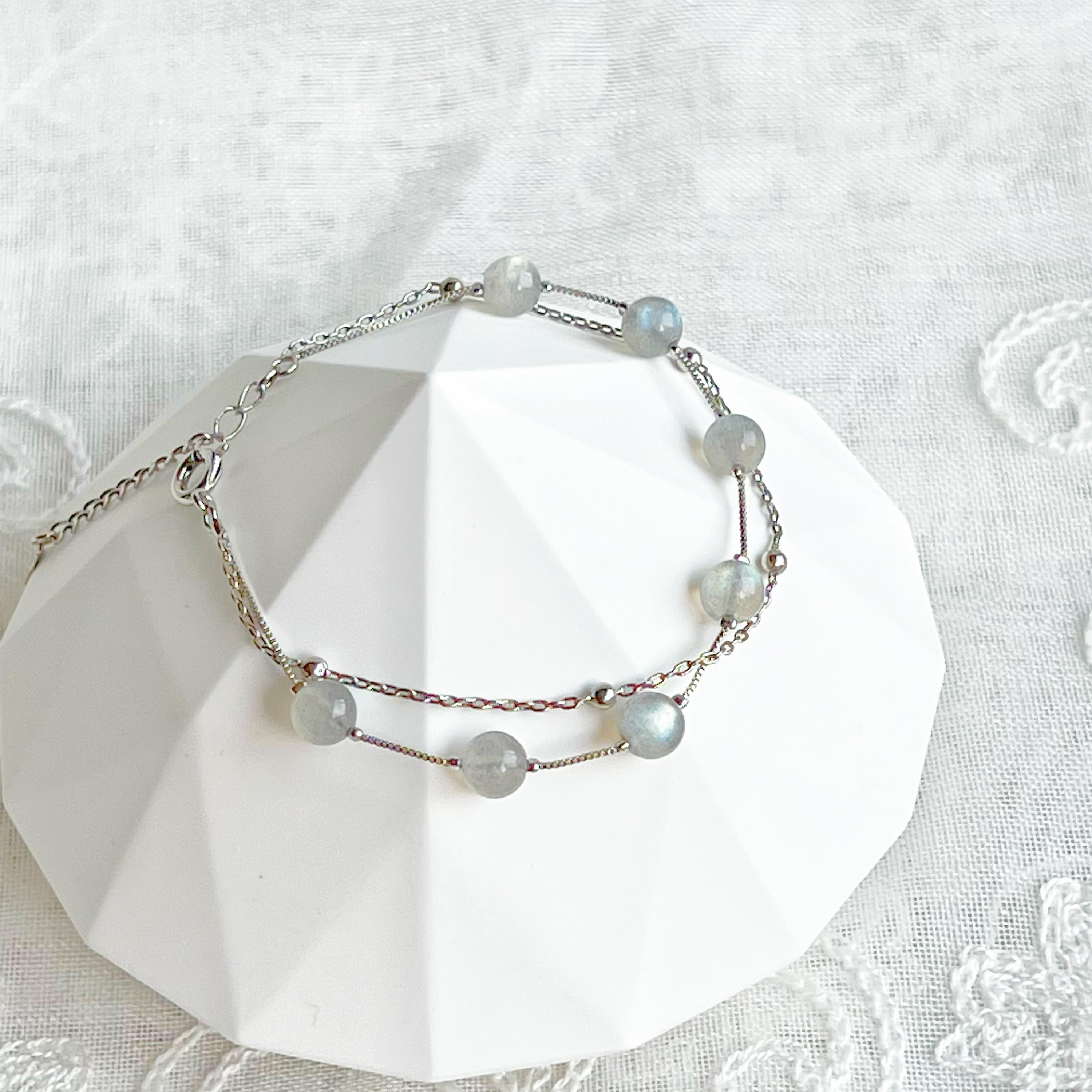 Moonstone Silver Double Chain Bracelet featuring 6mm moonstone beads and silver plated bronze chain, elegantly displayed.