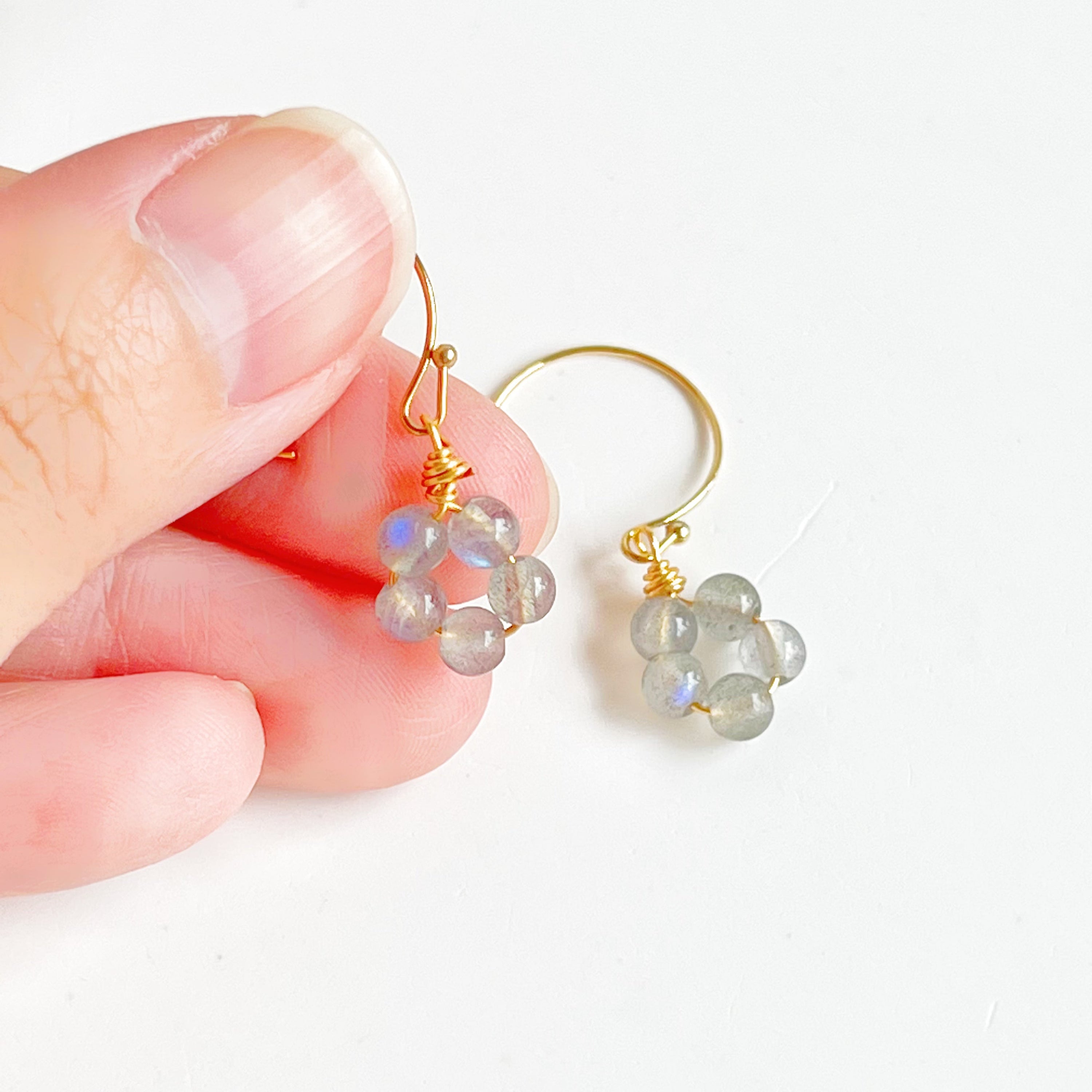 Handmade Moonstone Flower Earrings with sterling silver studs, showcasing natural moonstones with unique imperfections.