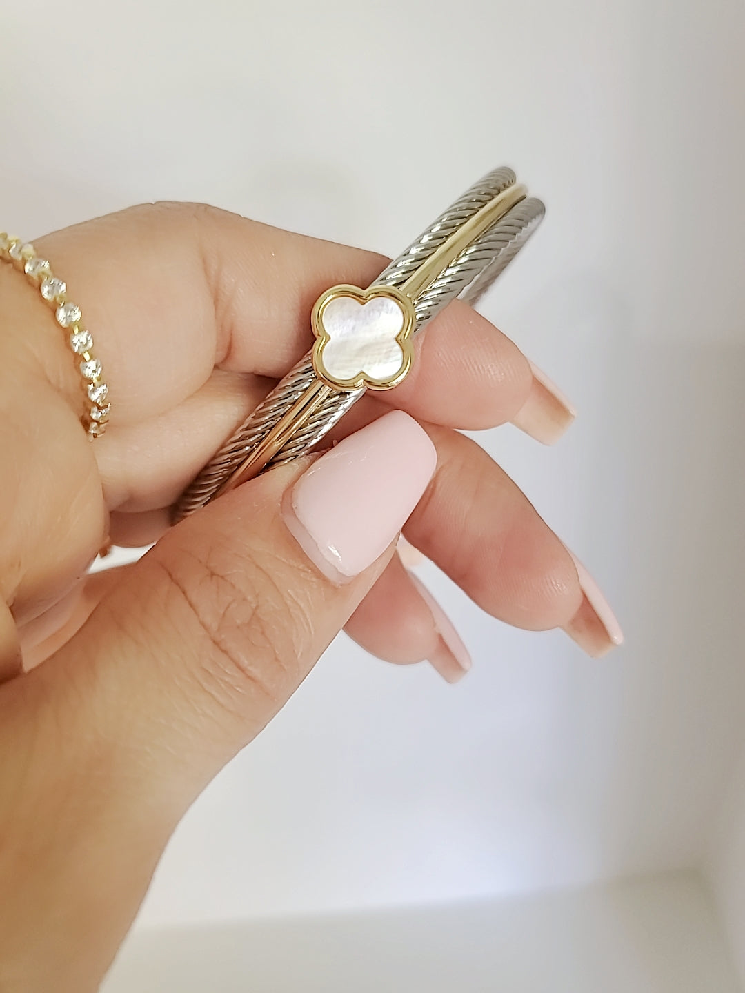 Elegant Mother of Pearl bangle bracelet with 18K Gold Filled clover pattern, showcasing a delicate cable design.