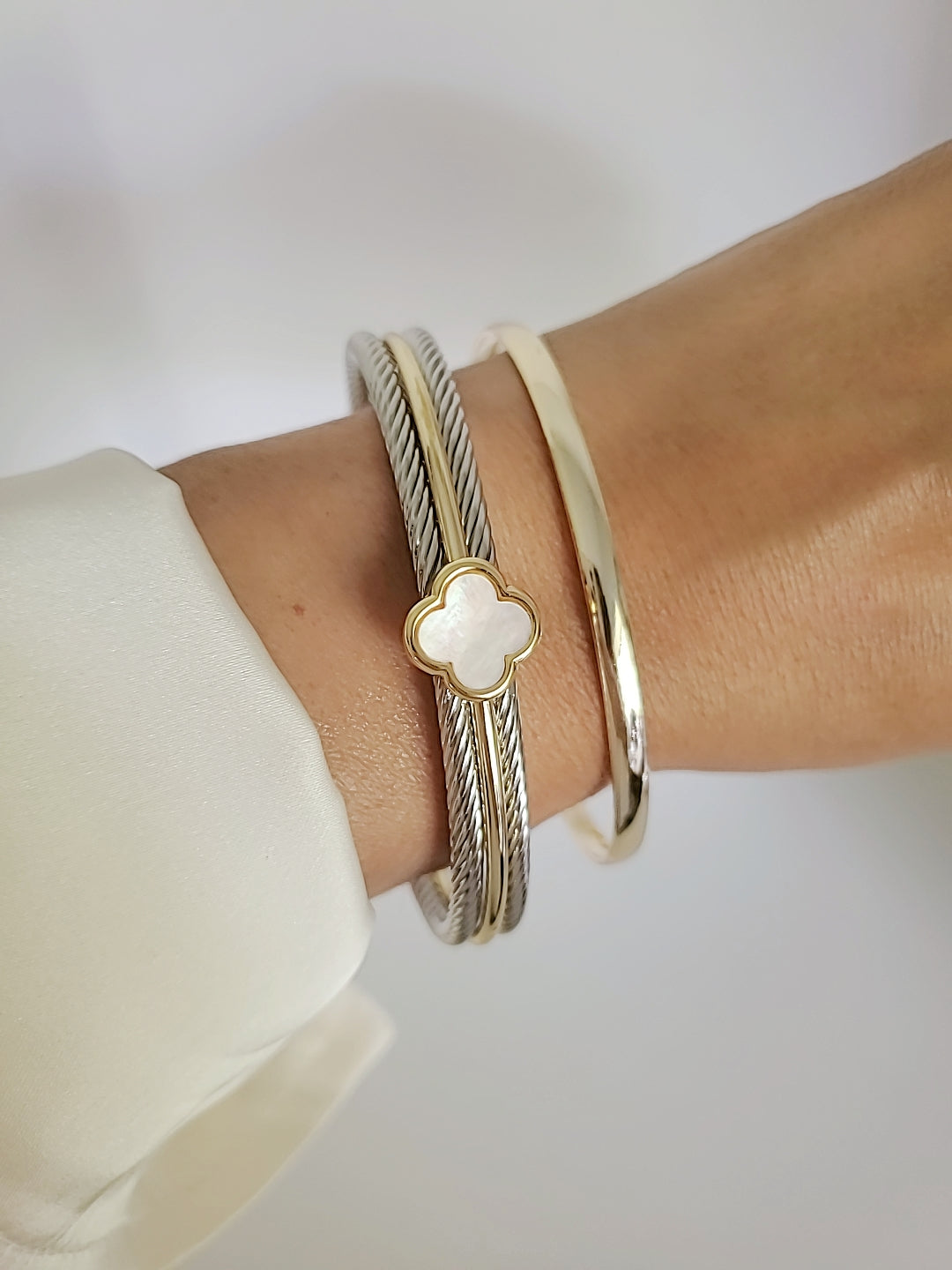 Elegant Mother of Pearl bangle bracelet with 18K Gold Filled clover pattern, showcasing a delicate cable design.