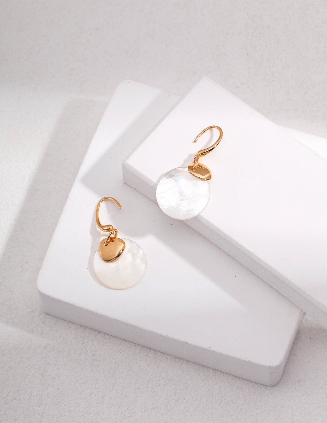 Elegant Mother of Pearl Dangle Earrings featuring natural pearls and gold vermeil, showcasing their beautiful luster and design.