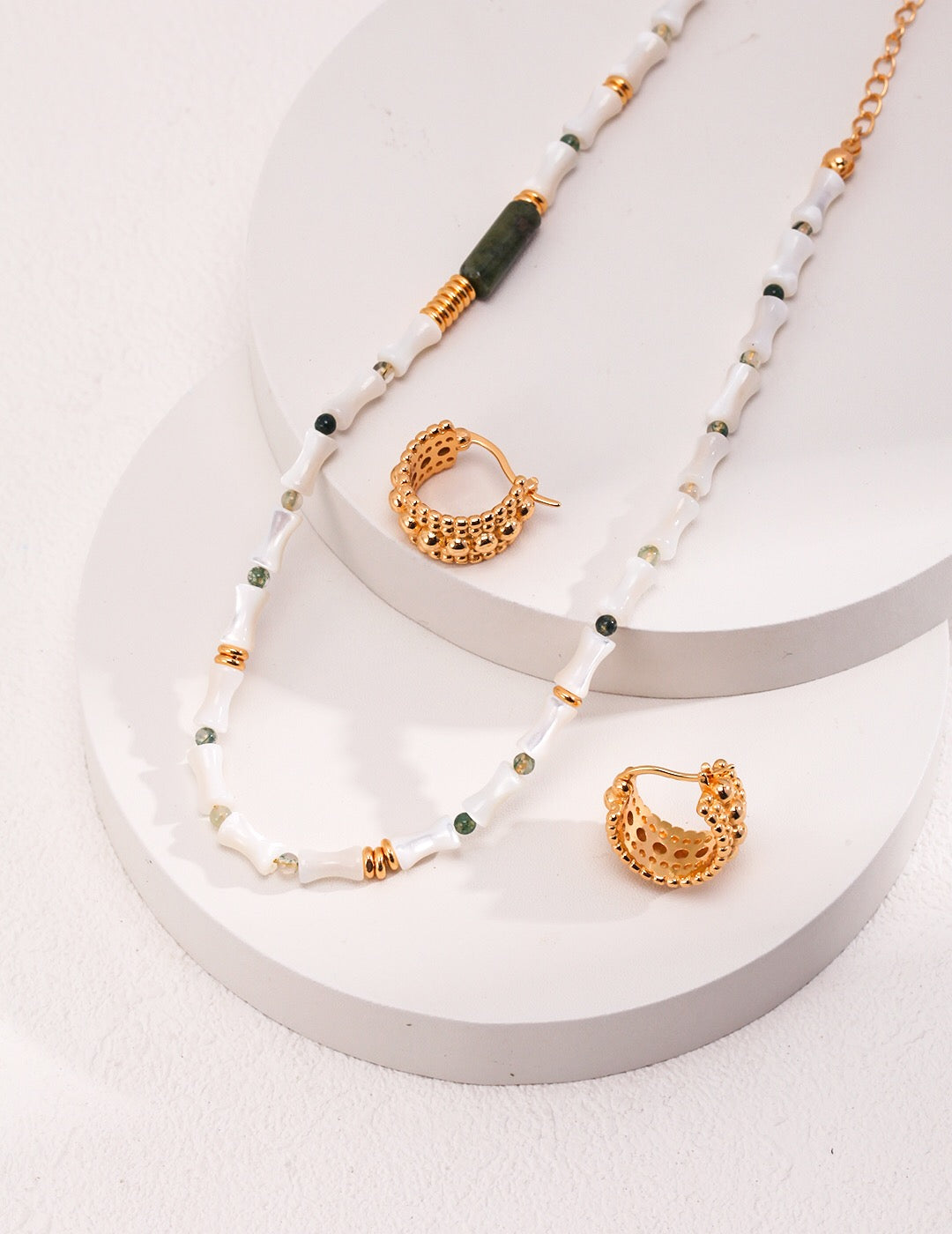 A beautifully handcrafted Mother-of-pearl Bamboo Beaded Necklace featuring aquatic agate beads and gold vermeil accents, elegantly displayed.