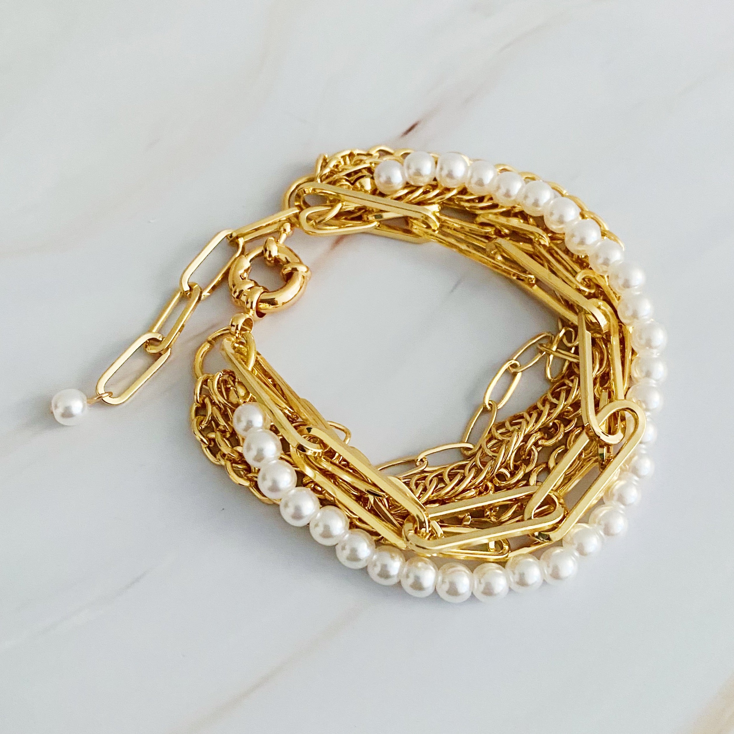 A stylish Multi Chain & Pearl Bracelet featuring trendy chains and elegant acrylic pearls, perfect for any occasion.