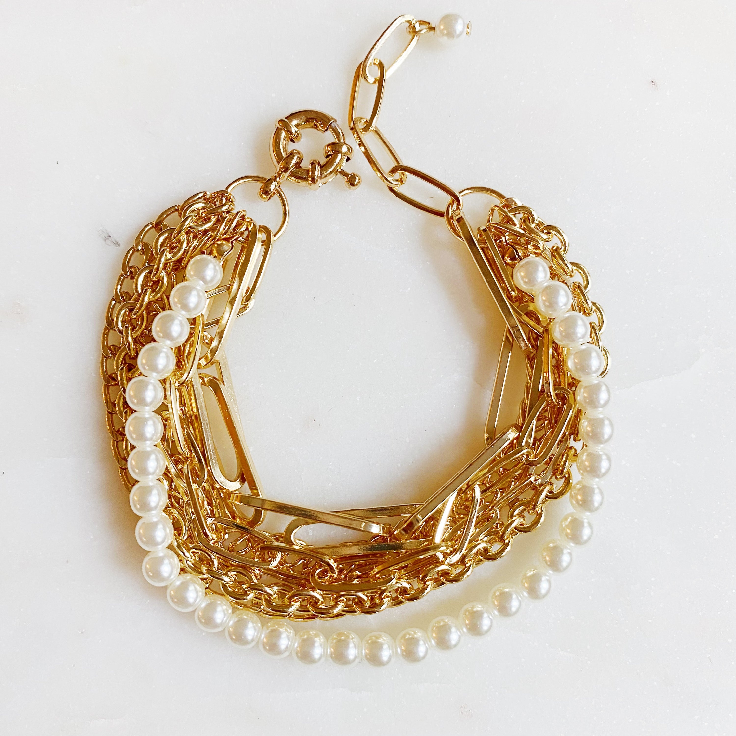 A stylish Multi Chain & Pearl Bracelet featuring trendy chains and elegant acrylic pearls, perfect for any occasion.