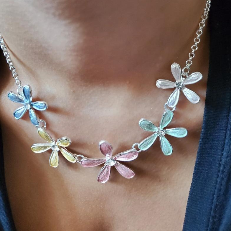 Multi Flower Link Necklace Set featuring pastel flowers and crystal insets, with matching earrings, displayed elegantly.