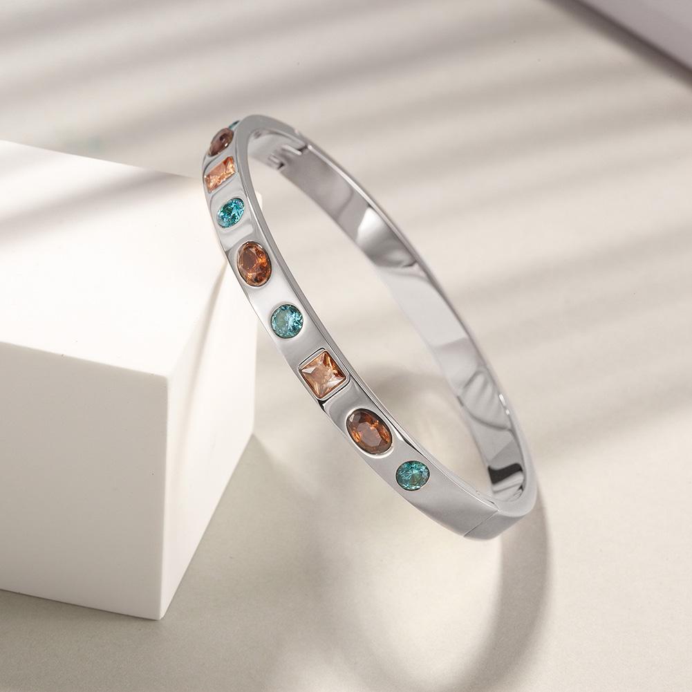 Elegant Multi-Stone Hinge Bangle made of surgical stainless steel with gold plating, featuring a stylish hinge design.