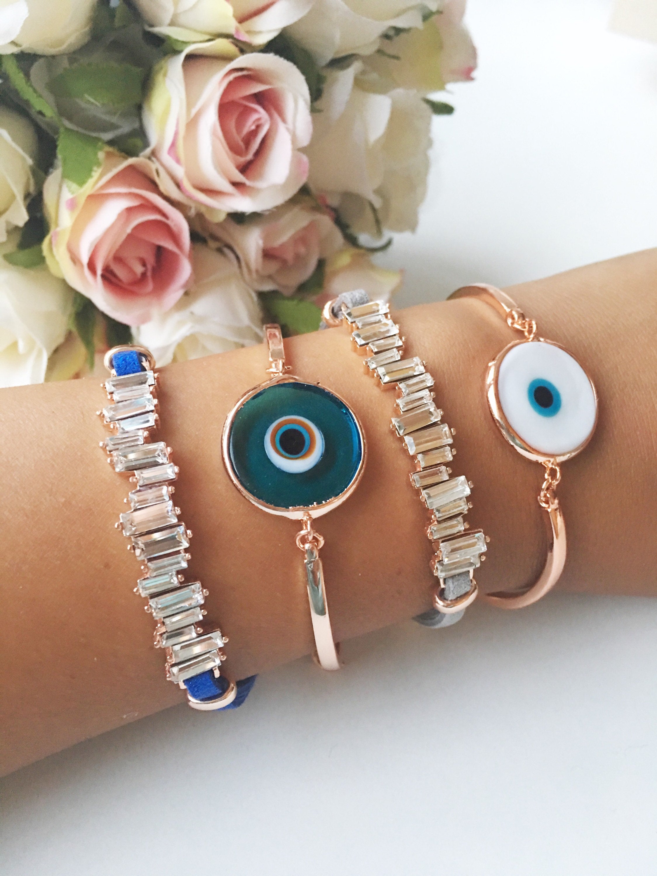 Murano Evil Eye Bracelet featuring a blue evil eye bead, adjustable design, and durable stainless steel material, displayed on a soft background.