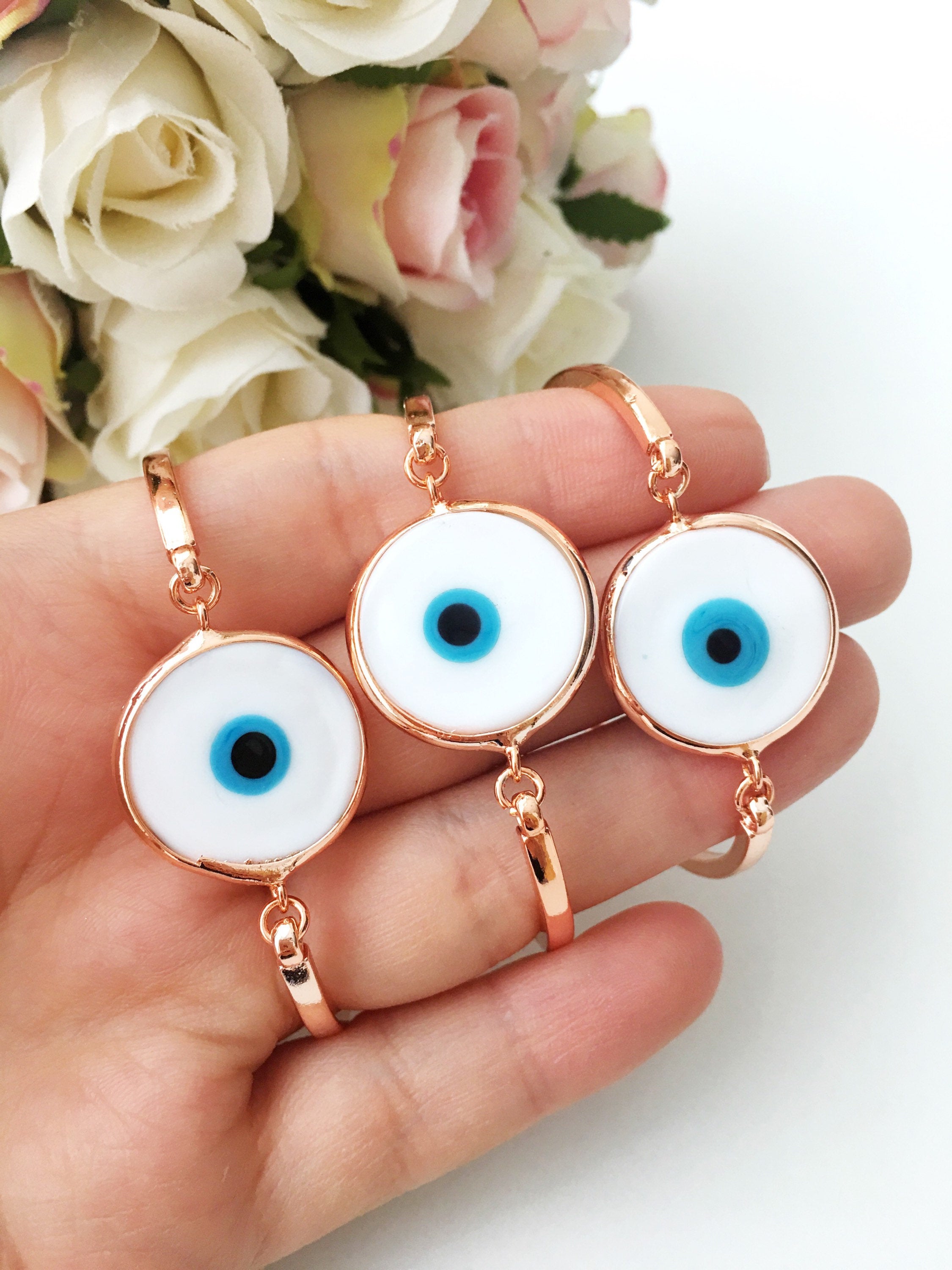 Murano Evil Eye Bracelet featuring a blue evil eye bead, adjustable design, and durable stainless steel material, displayed on a soft background.