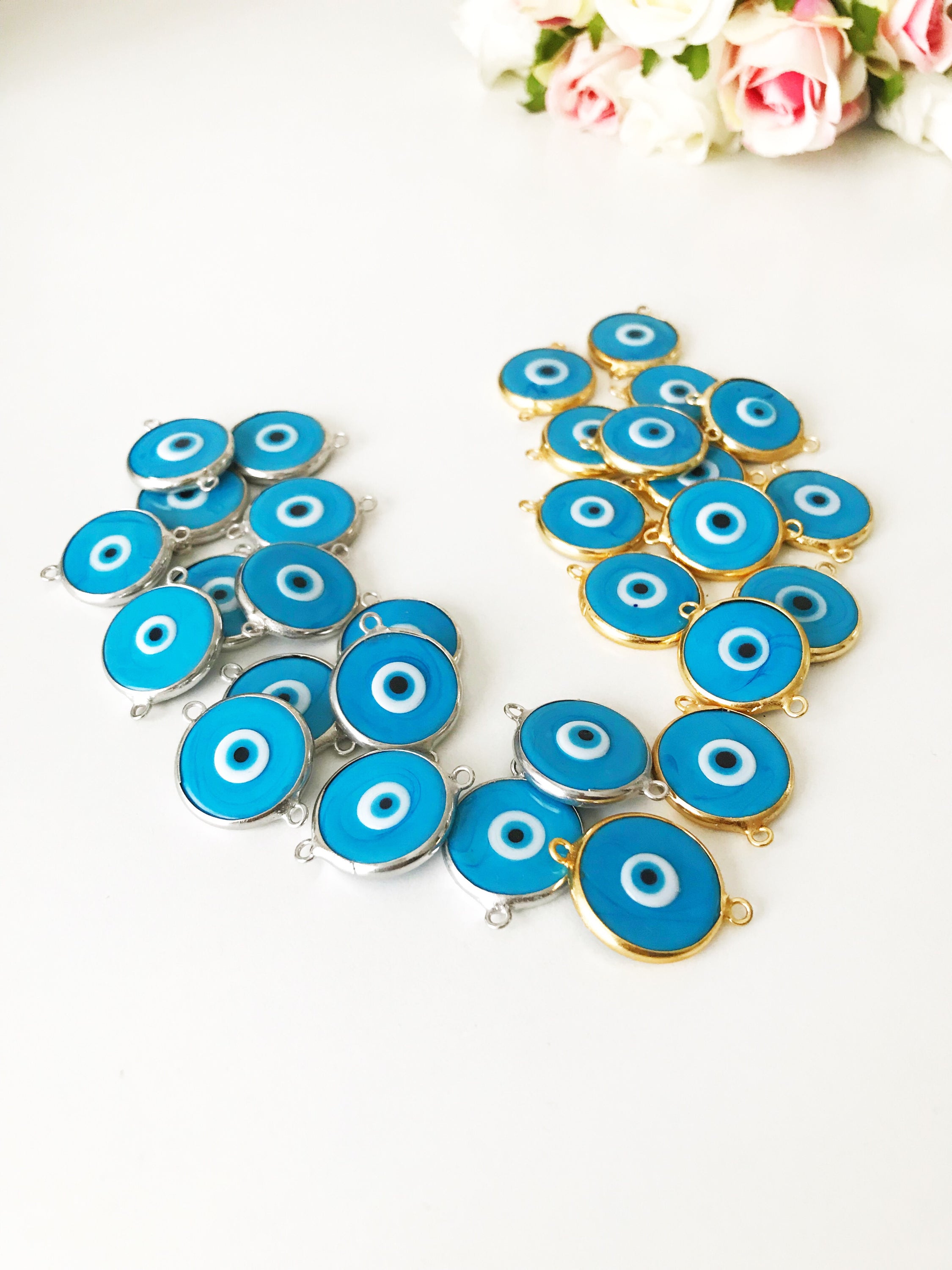 Murano evil eye connector bead in baby blue with gold and silver frames, handmade from Murano glass.