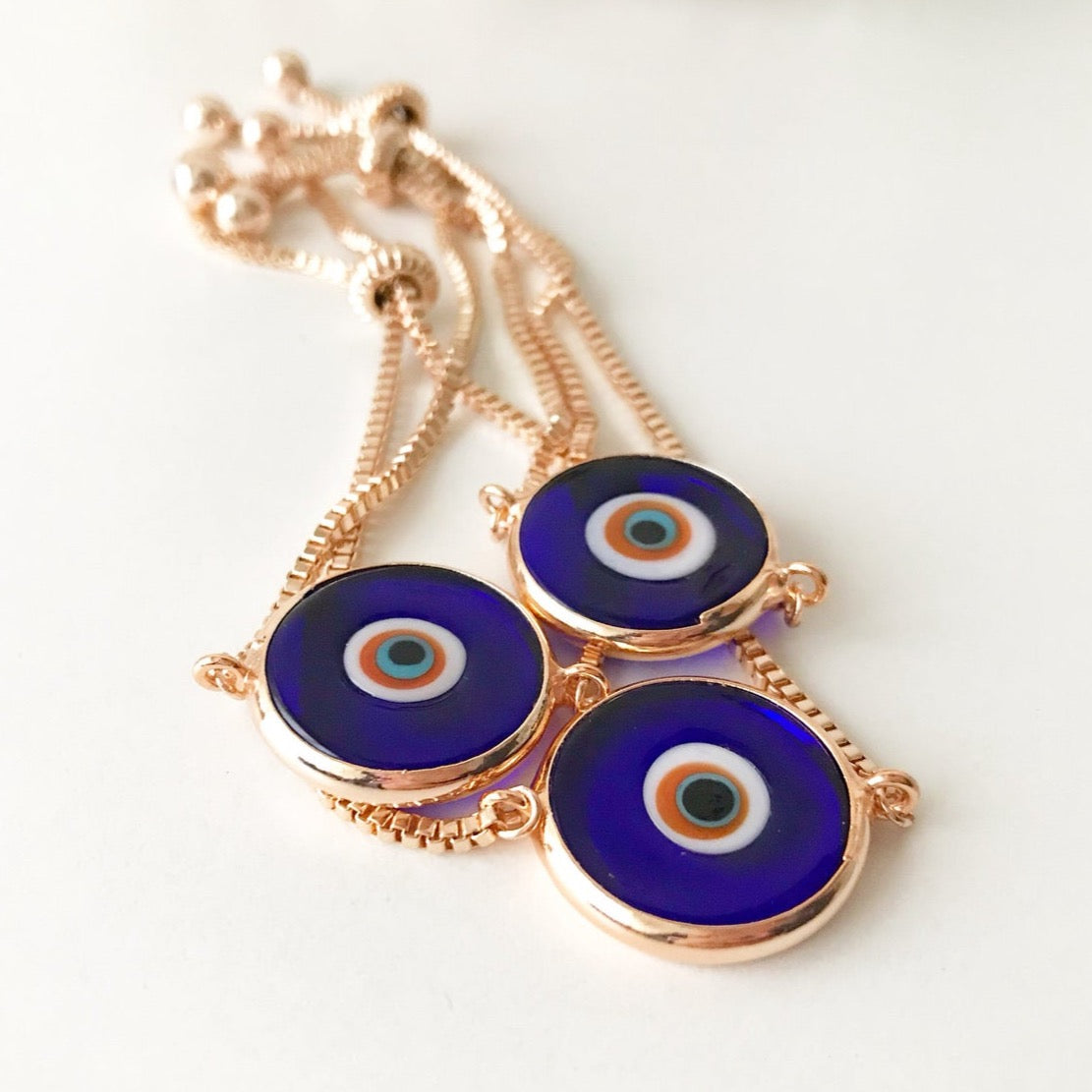 Murano Glass Evil Eye Bracelet featuring a blue glass bead on an adjustable rose gold stainless steel chain, symbolizing protection and style.