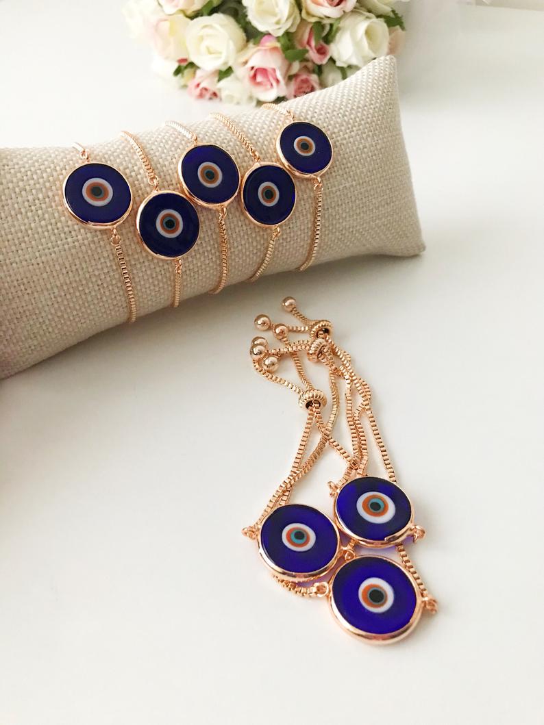 Murano Glass Evil Eye Bracelet featuring a blue glass bead on an adjustable rose gold stainless steel chain, symbolizing protection and style.