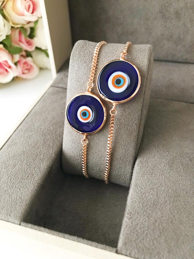 Murano Glass Evil Eye Bracelet featuring a blue glass bead on an adjustable rose gold stainless steel chain, symbolizing protection and style.