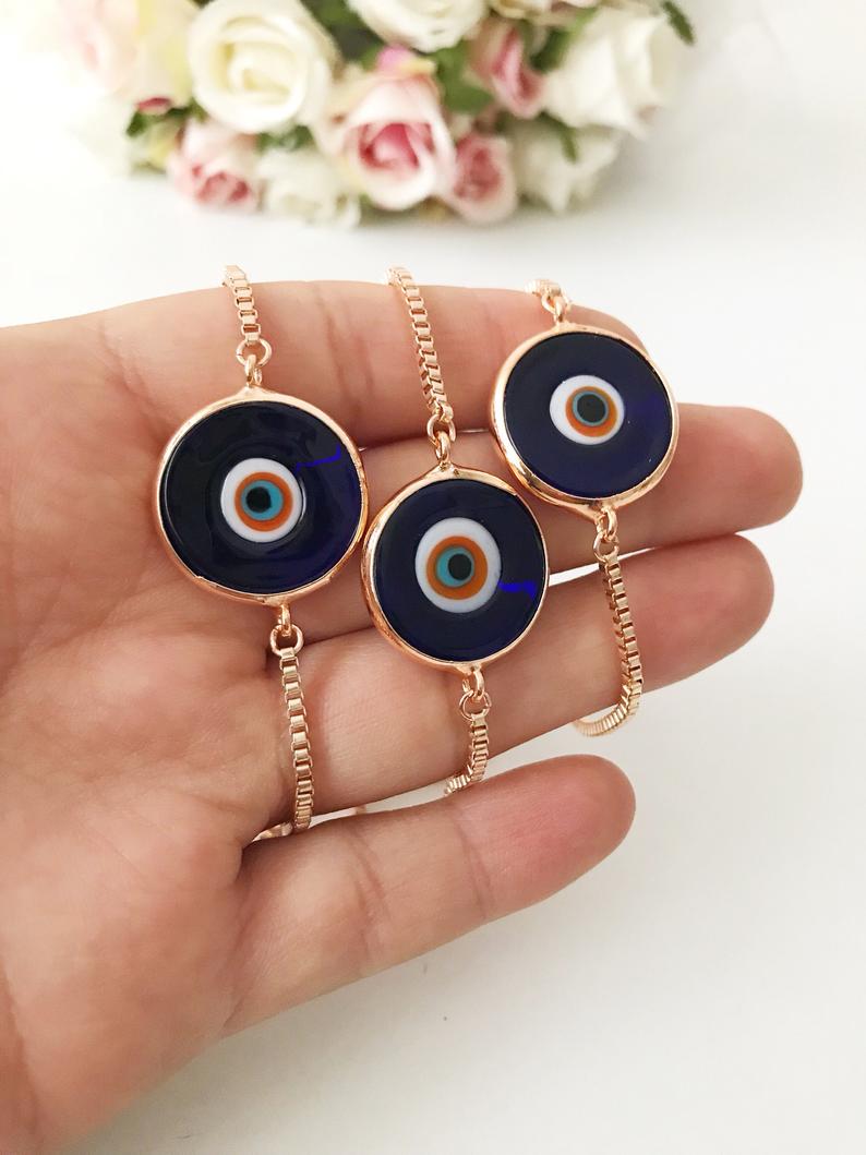 Murano Glass Evil Eye Bracelet featuring a blue glass bead on an adjustable rose gold stainless steel chain, symbolizing protection and style.