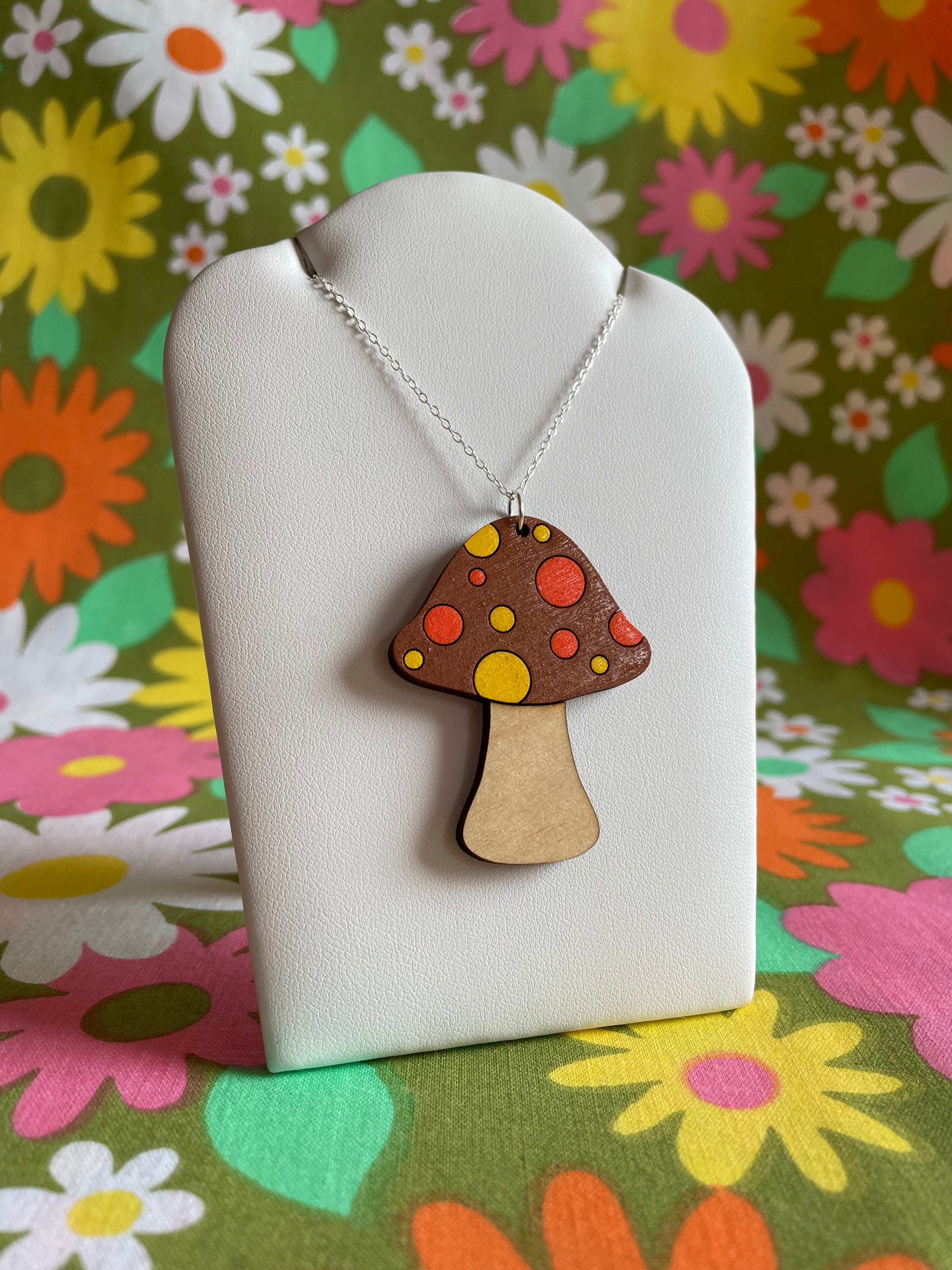 A beautifully crafted Mushroom Necklace featuring floral designs, made from sustainable Birch Plywood, showcasing intricate laser-cut details.