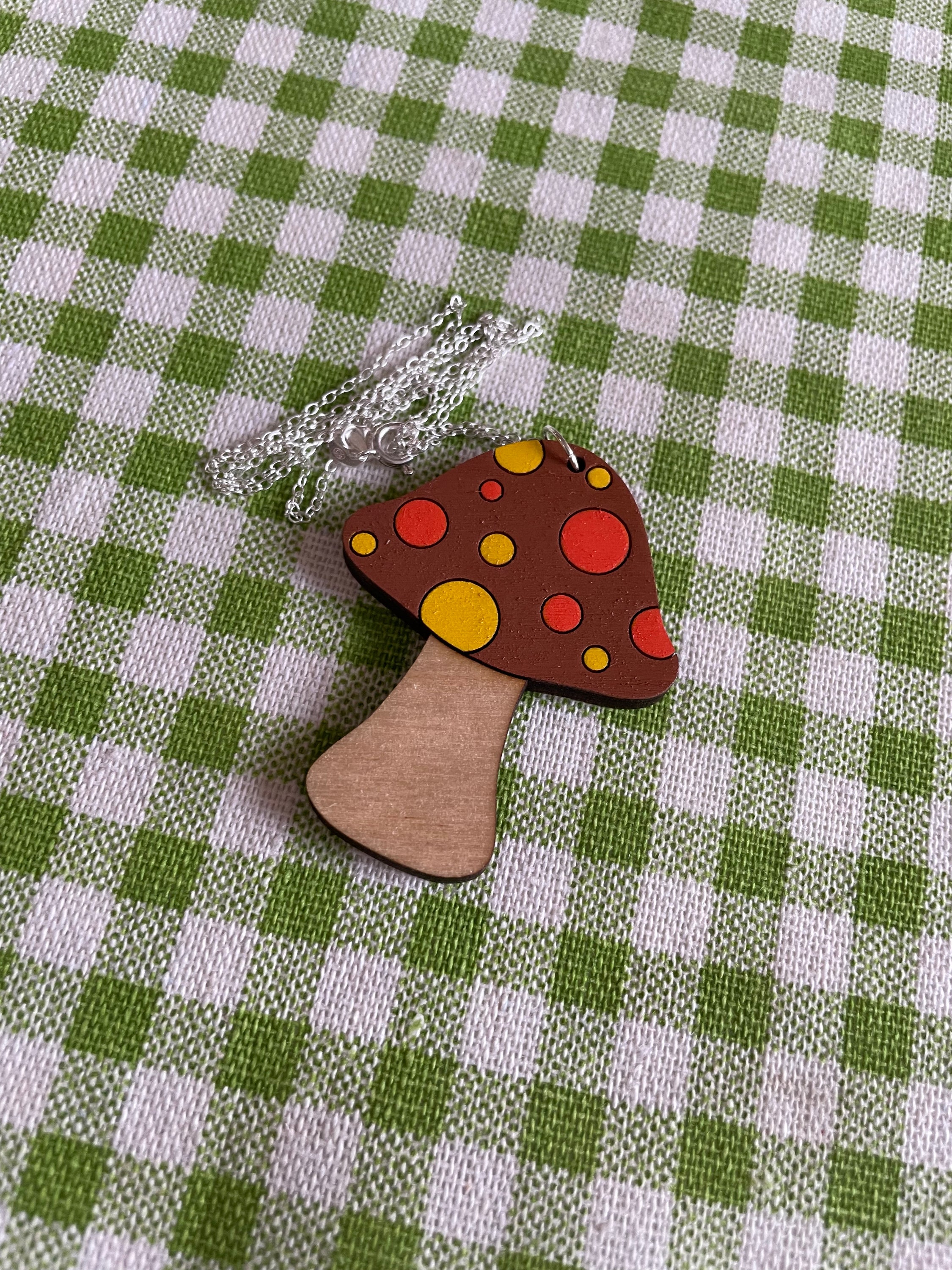 A beautifully crafted Mushroom Necklace featuring floral designs, made from sustainable Birch Plywood, showcasing intricate laser-cut details.