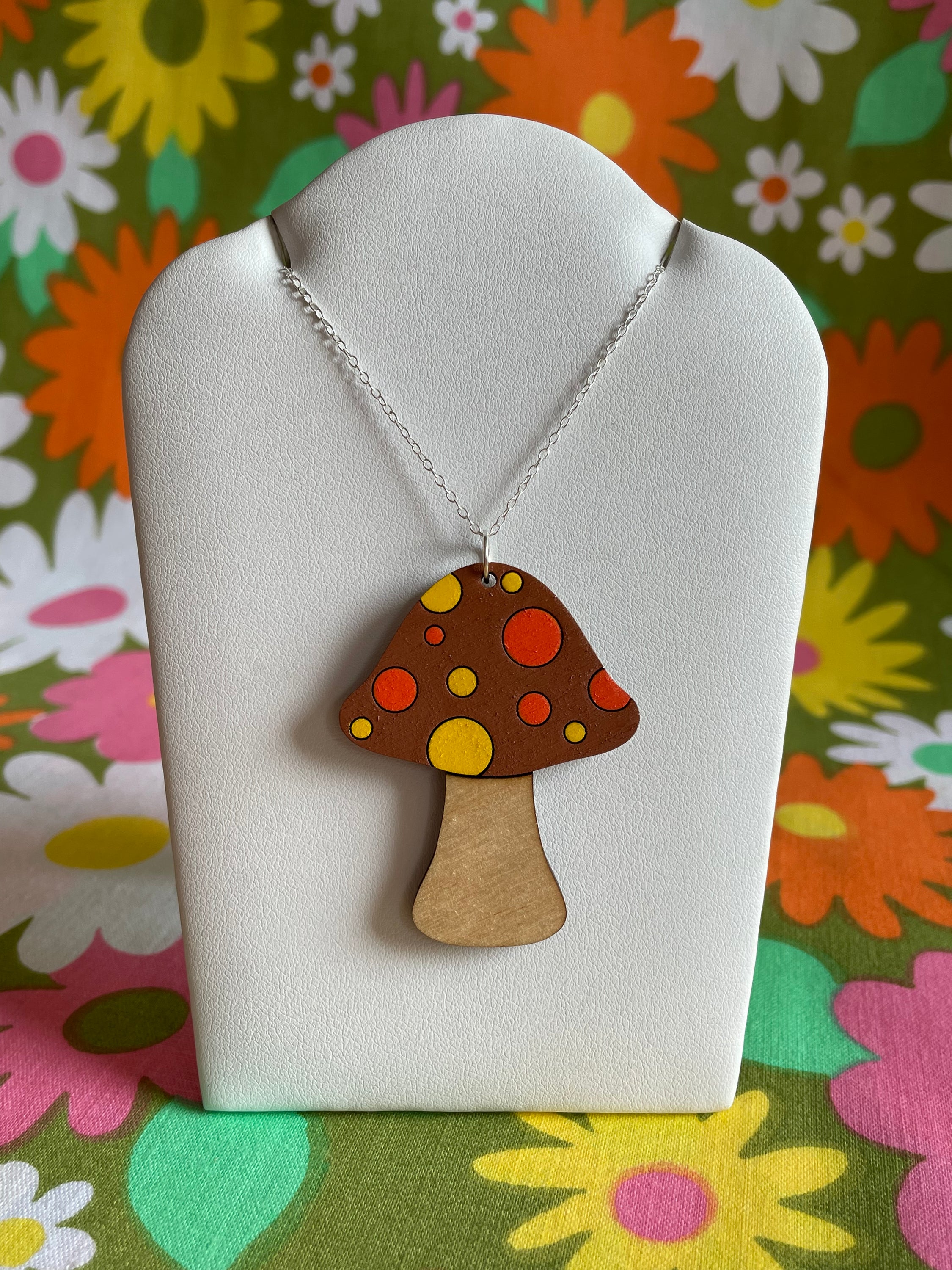 A handcrafted wooden mushroom necklace featuring spots, made from sustainable Birch Plywood, showcasing a unique vintage-inspired design.