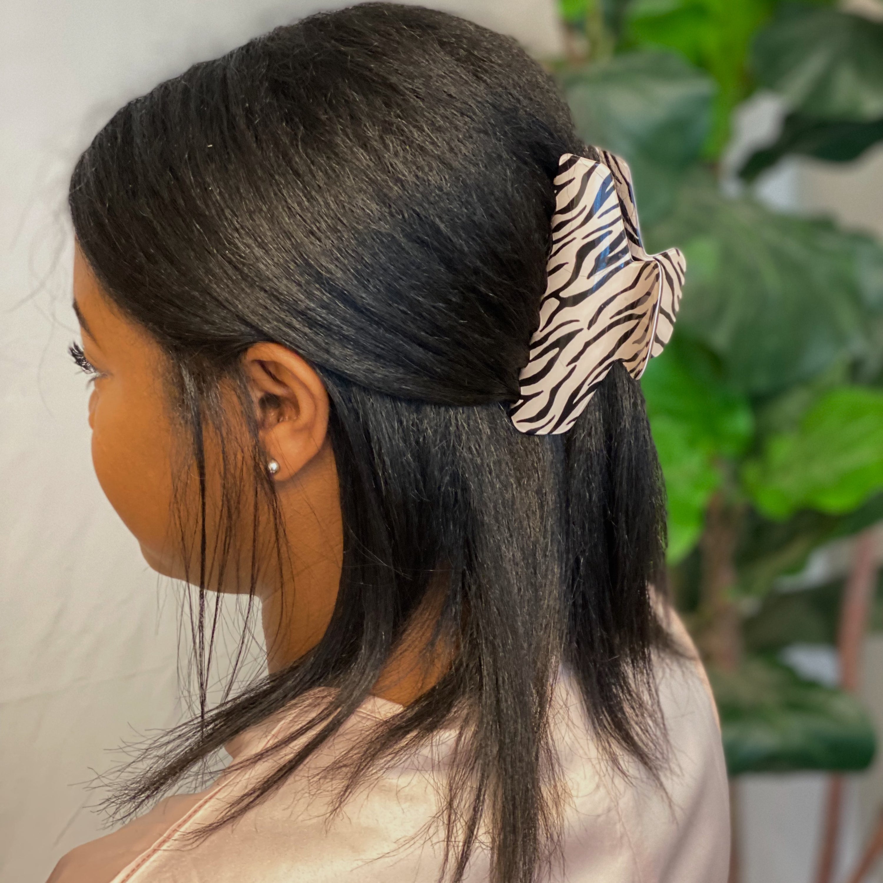 Muted zebra print hair claw clip made of durable acrylic, designed to hold thick hair securely with a stylish aesthetic.