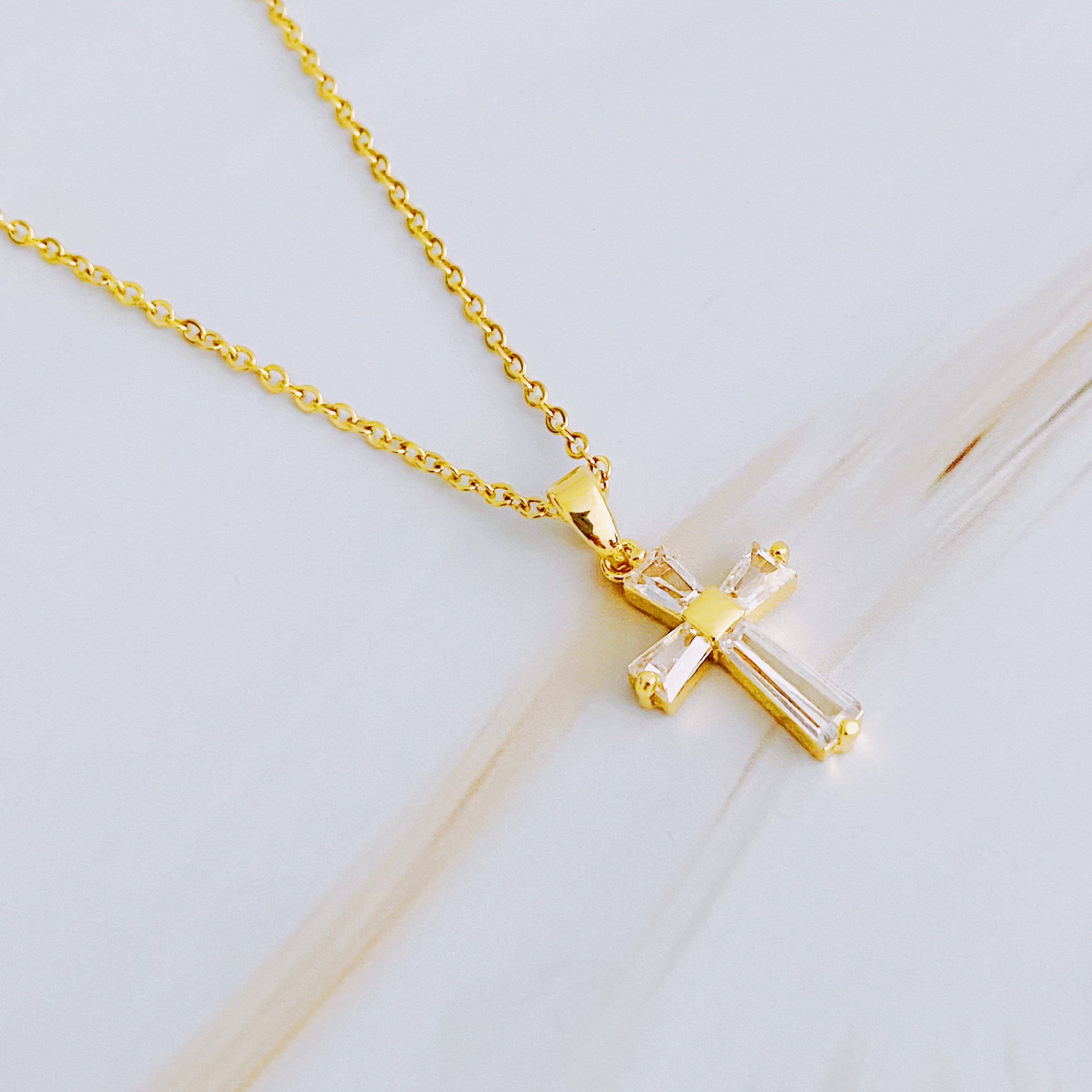 My Dear Crystal Cross Necklace featuring a clear crystal cross pendant on a delicate gold chain.