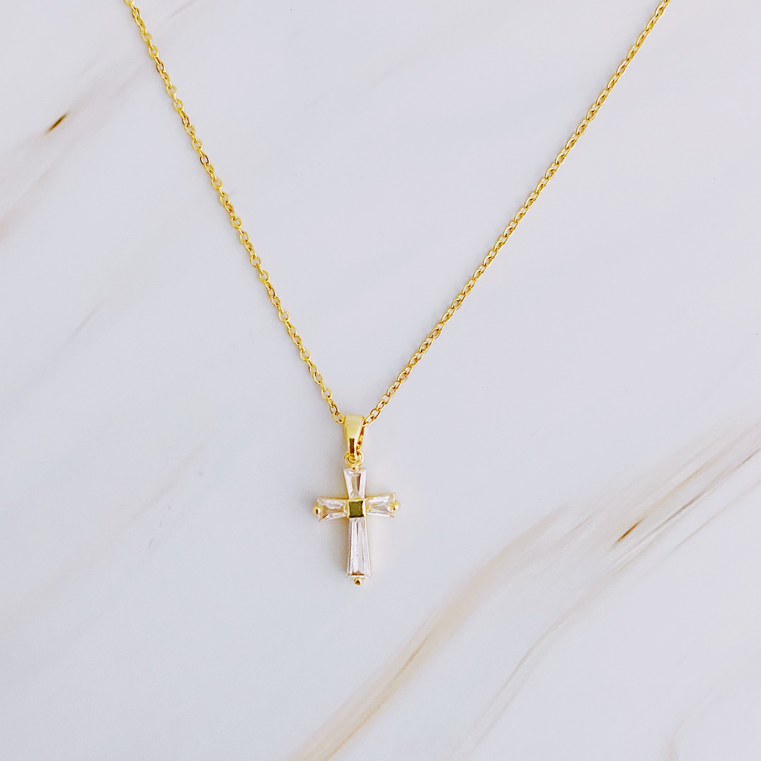 My Dear Crystal Cross Necklace featuring a clear crystal cross pendant on a delicate gold chain.