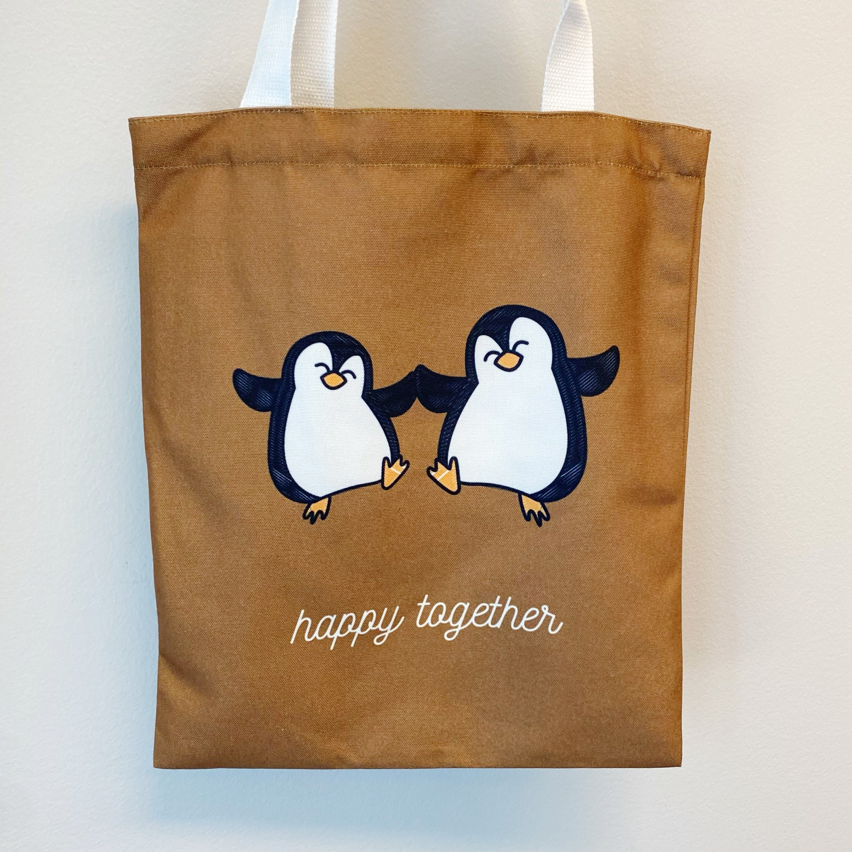 A stylish My Happy Canvas Tote featuring a positive graphic print, perfect for carrying books and small devices.