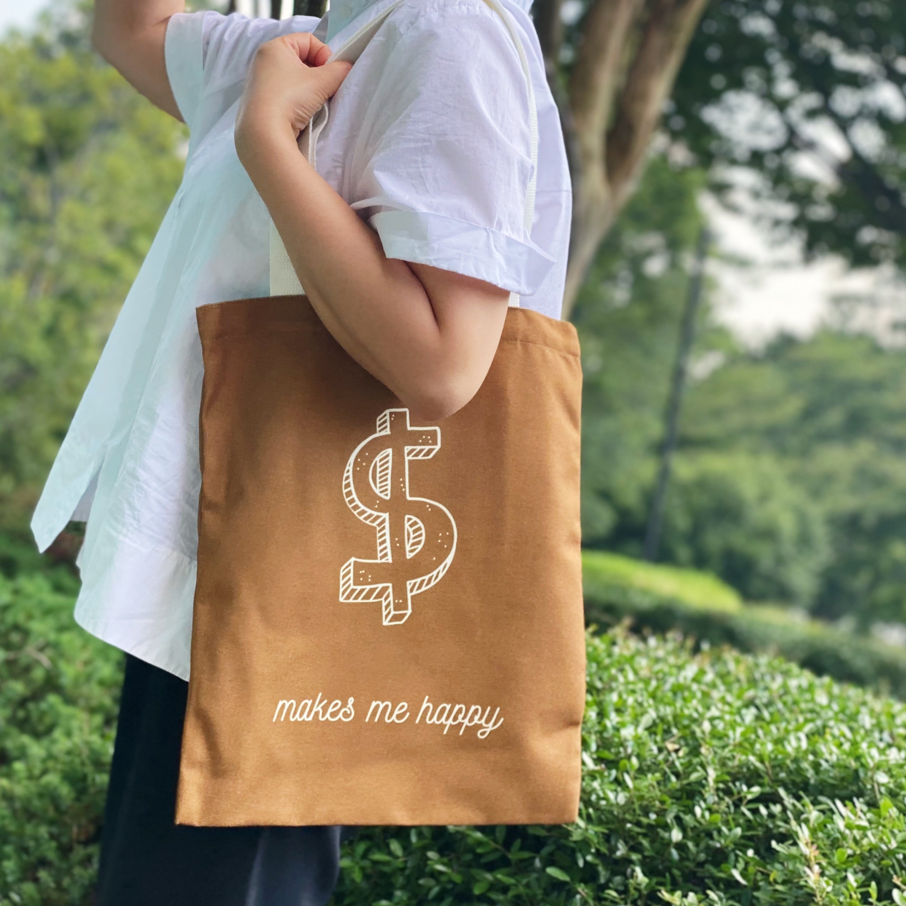 A stylish My Happy Canvas Tote featuring a positive graphic print, perfect for carrying books and small devices.