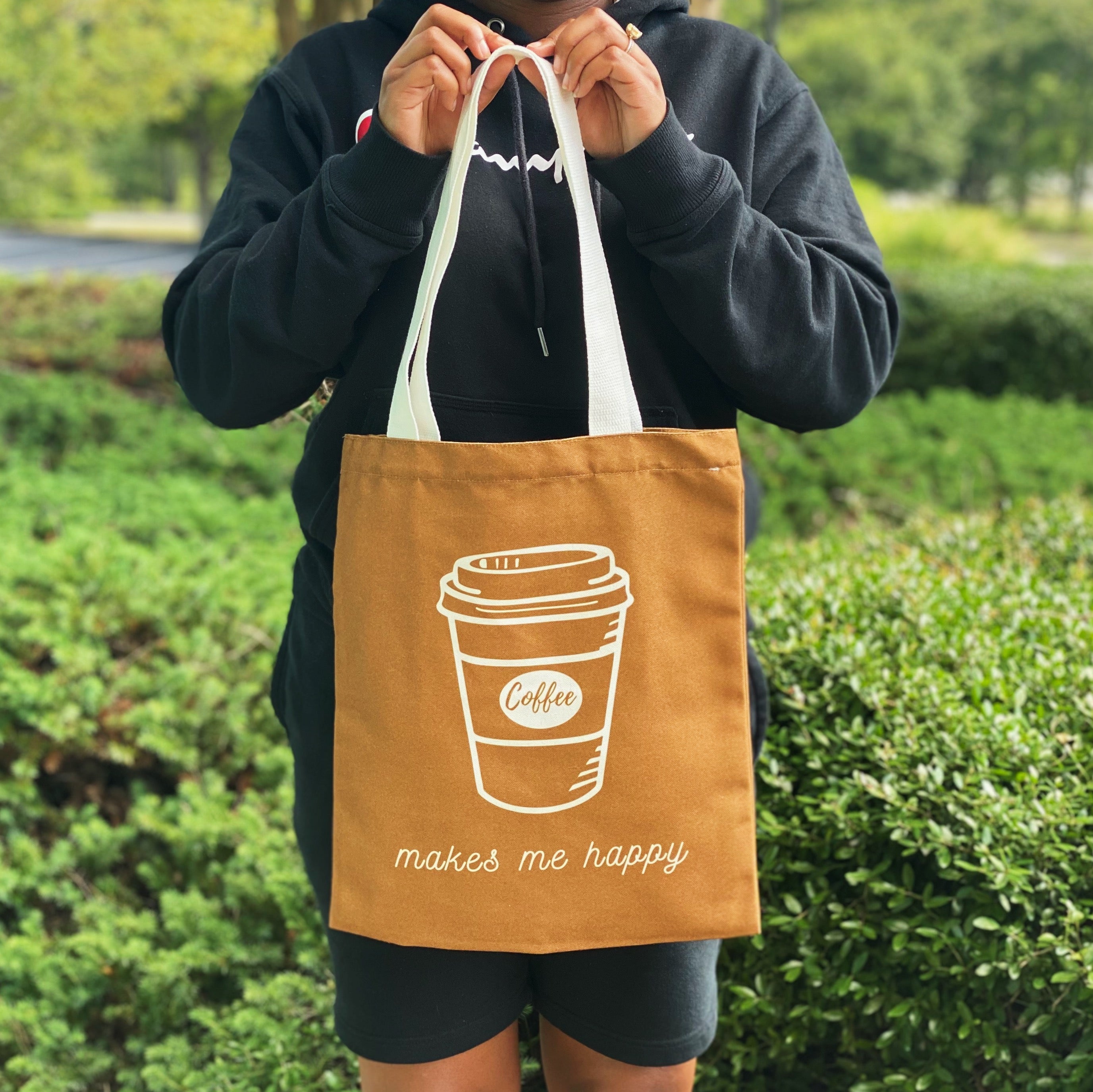 A stylish My Happy Canvas Tote featuring a positive graphic print, perfect for carrying books and small devices.