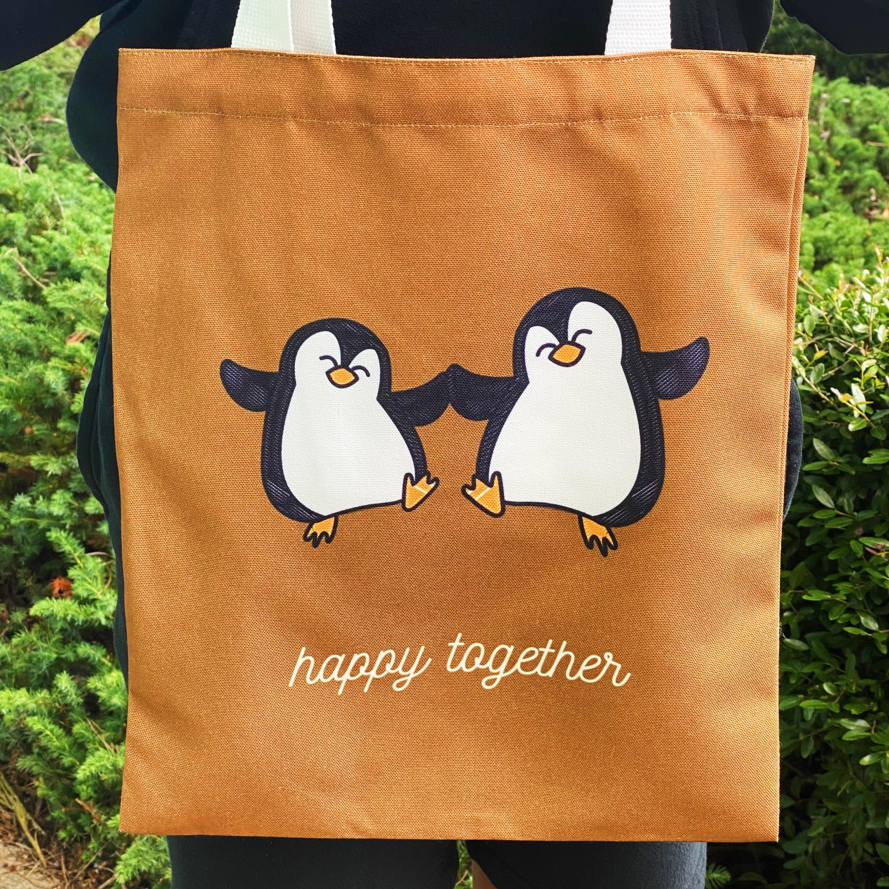 A stylish My Happy Canvas Tote featuring a positive graphic print, perfect for carrying books and small devices.