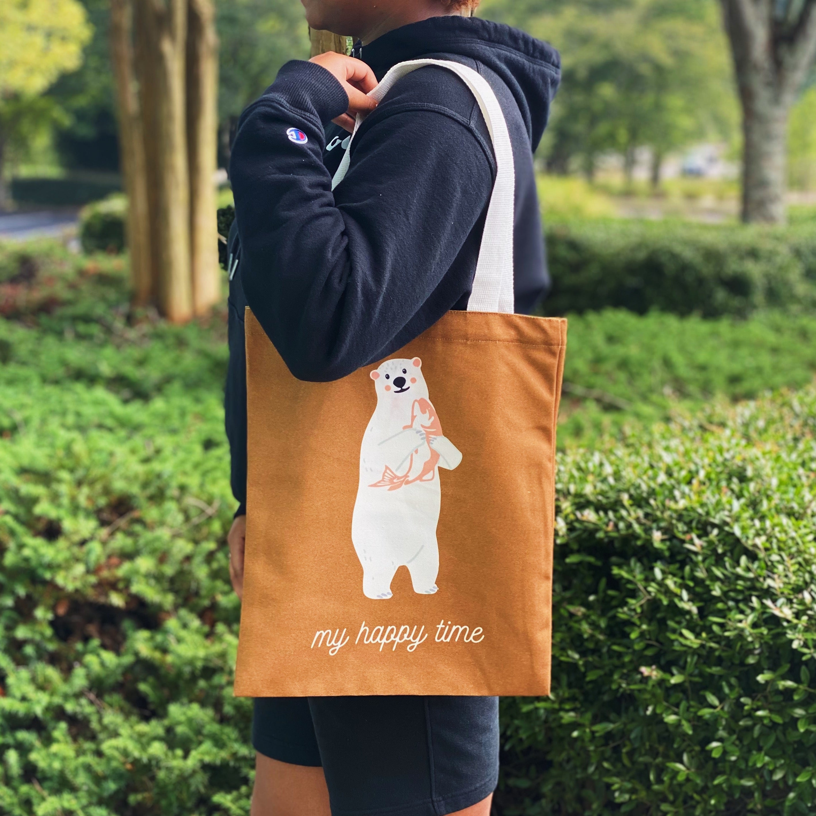 A stylish My Happy Canvas Tote featuring a positive graphic print, perfect for carrying books and small devices.