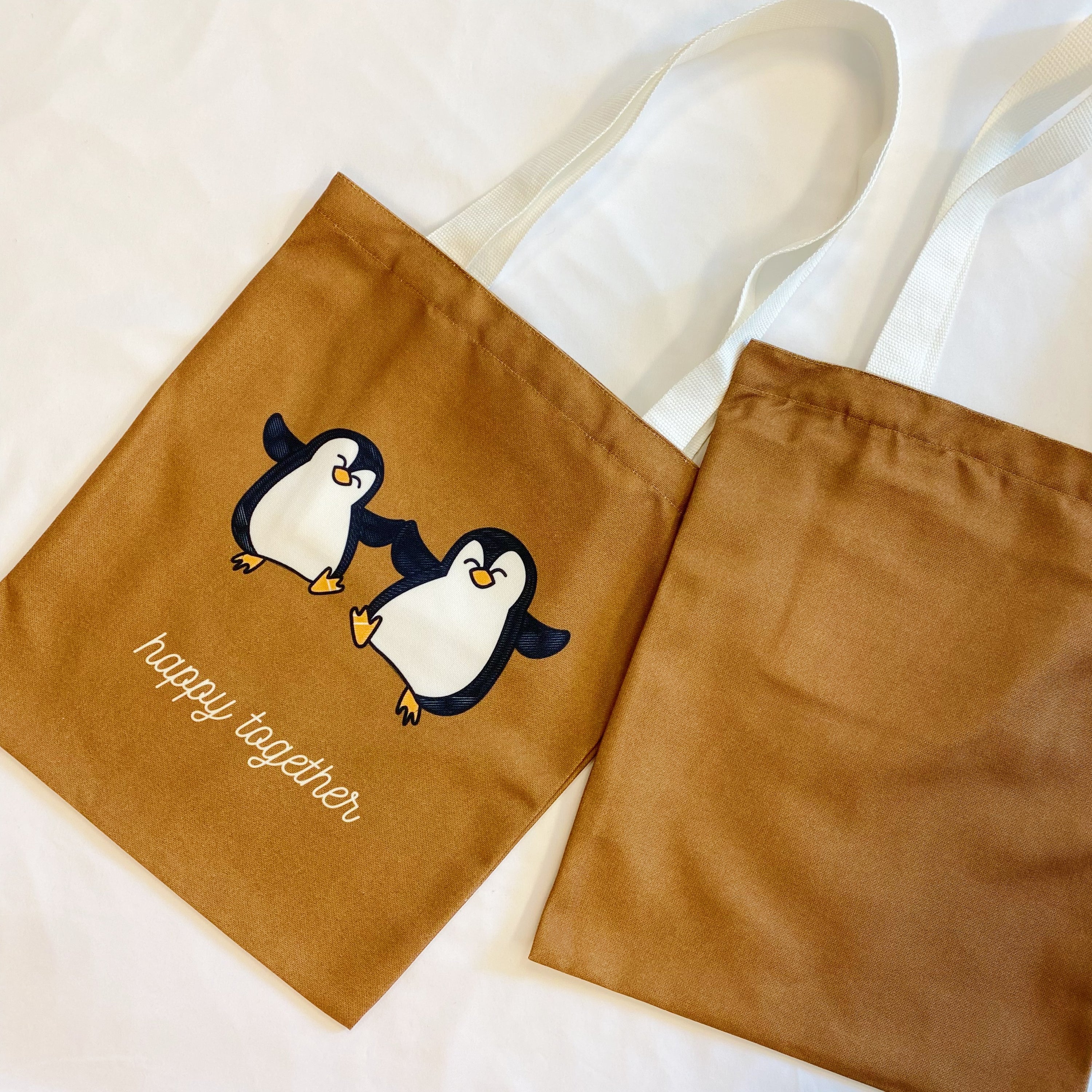 A stylish My Happy Canvas Tote featuring a positive graphic print, perfect for carrying books and small devices.